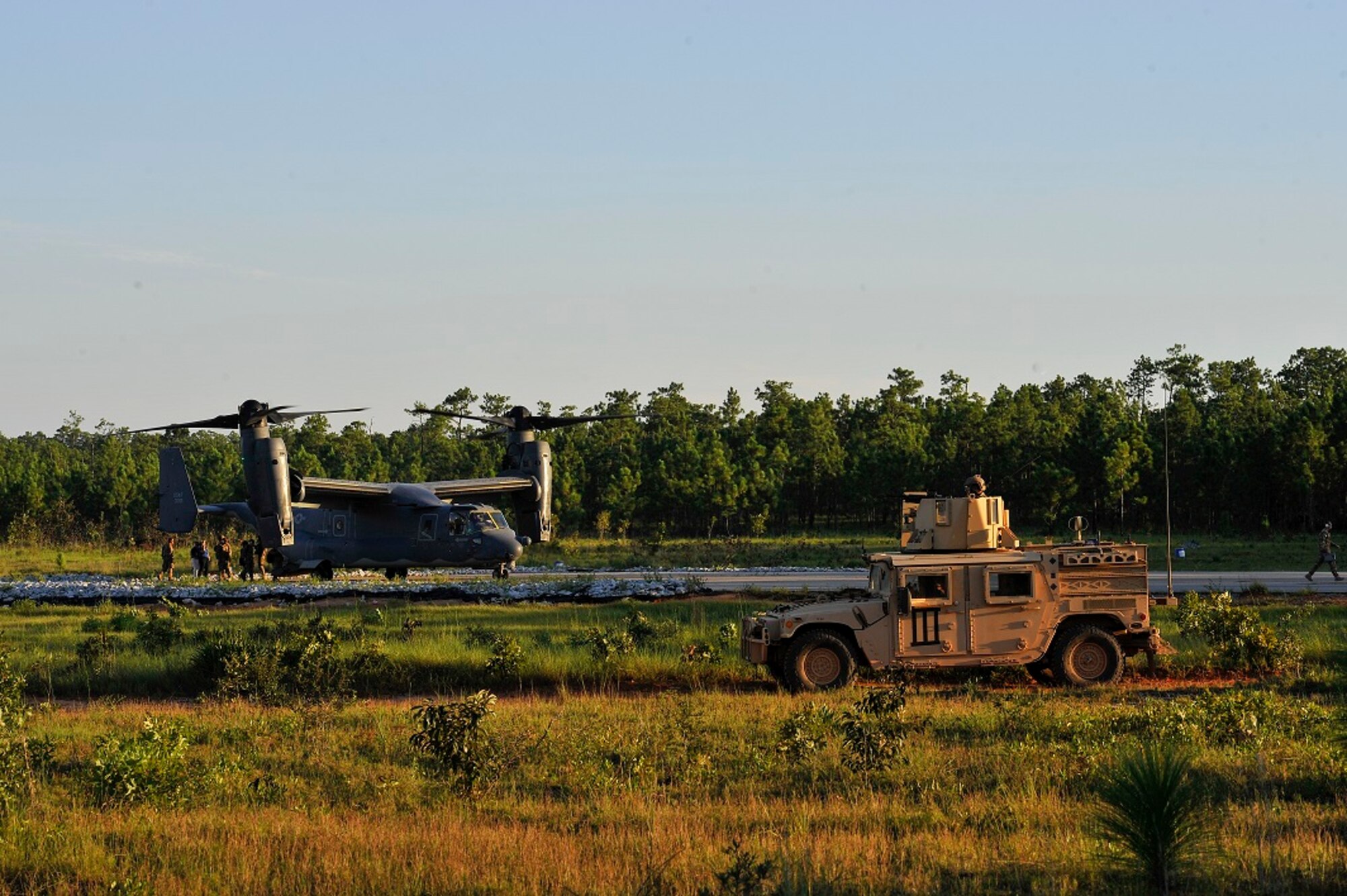 Air Commandos with the 24th Special Operations Wing conduct simulated security as CV-22 Ospreys prepare to land on Eglin Range Complex, Fla., Aug. 26, 2015. More than 20 national civic leaders were onboard the Osprey as part of the Senior Leader Engagement Program tour. AFSOC represented the Air Force portion of the weeklong tour, which included stops at Army, Navy, Marine and Coast Guard components. (U.S. Air Force photo by Airman Kai White/Released)