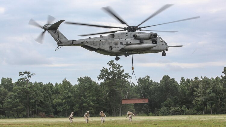 Marine pilots in a CH-53E Super Stallion with Marine Heavy Helicopter Training Squadron 302, carry away an 8,500-pound high beam during an external lift exercise aboard Camp Lejeune, N.C., Aug. 25, 2015. The CH-53E completed a short circle pass, then slowly descended to allow Marines on the ground to disconnect the beam. 
