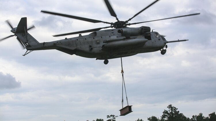 Marine pilots in a CH-53E Super Stallion with Marine Heavy Helicopter Training Squadron 302, carry away an 8,500-pound high beam during an external lift exercise at Marine Corps Base Camp Lejeune, N.C., Aug. 25, 2015. As the CH-53E hovered several yards above, on-the-ground Marines worked together to attach a beam weighing 8,500 pounds to the aircraft’s cable. 