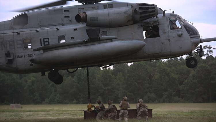 Marines with 2nd Transportation Support Battalion prepare to attach an 8,500-pound high beam to a pintle hook beneath a CH-53E Super Stallion during an external lift exercise at Marine Corps Base Camp Lejeune, N.C., Aug. 25, 2015. The 8,500 pound beam is only a fraction of the maximum 32,000 pounds the aircraft is capable of carrying. 