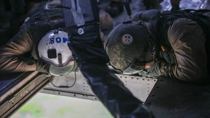 Marine air crew with Marine Heavy Helicopter Training Squadron 302 oversees ground Marines from within a CH-53E Super Stallion during an external lift exercise at Marine Corps Base Camp Lejeune, N.C., Aug. 25, 2015. The air crew within carefully observed the ground team to ensure they securely attached their 8,500-pound high beam to a pintle hook below. 