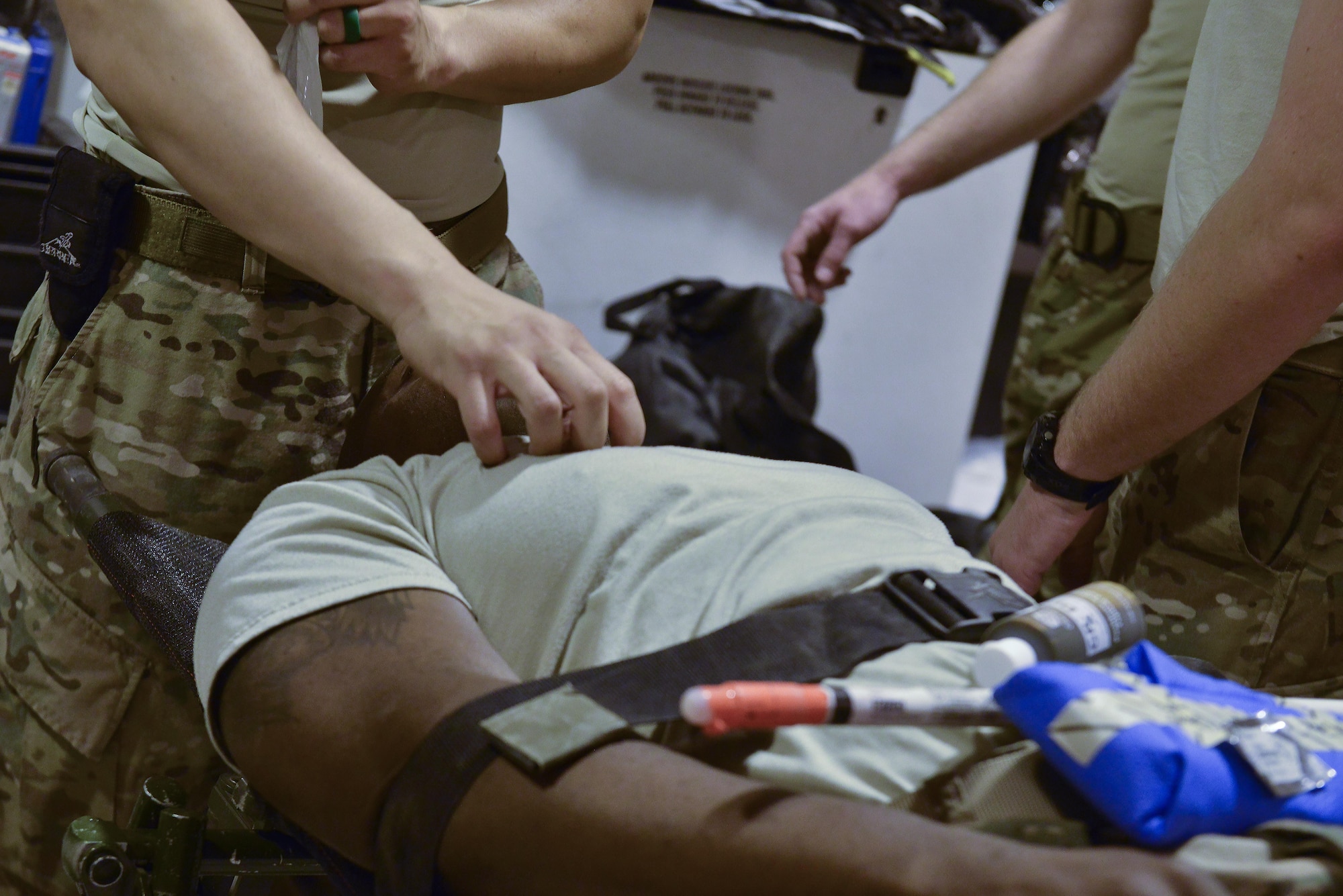 Airmen part of the 379th Expeditionary Medical Group Mobile Field Surgical Team discuss the actions and supplies needed during a timed training scenario to help with familiarization training August 28, 2015 at Al Udeid Air Base, Qatar. (U.S. Air Force photo/Staff Sgt. Alexandre Montes)