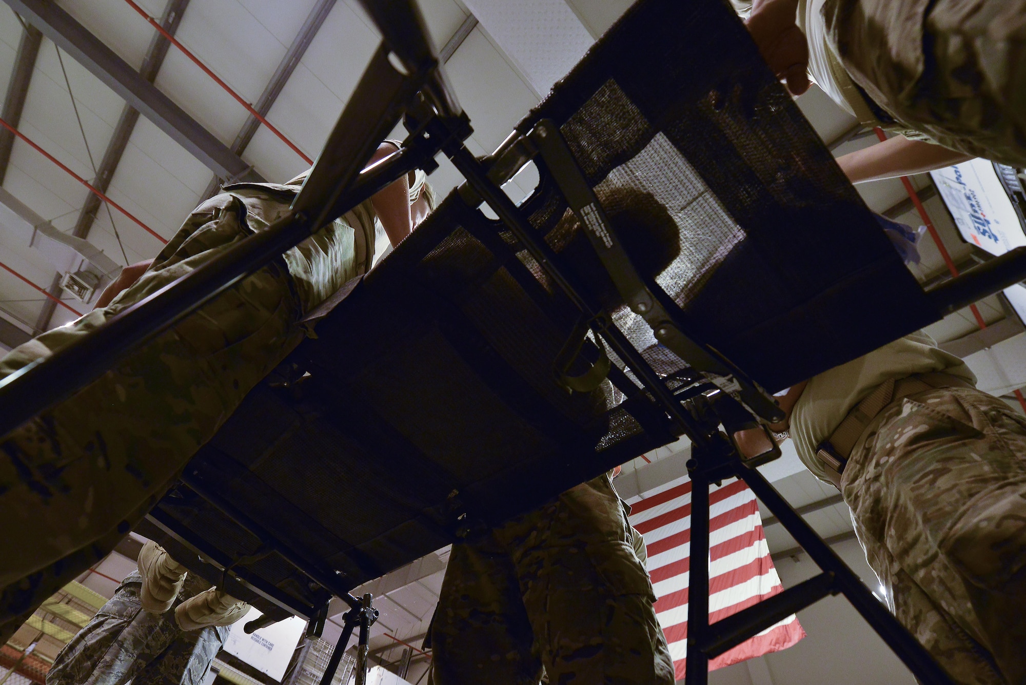 Airmen part of the 379th Expeditionary Medical Group Mobile Field Surgical Team discuss the actions and supplies needed during a timed training scenario to help with equipment familiarization training August 28, 2015 at Al Udeid Air Base, Qatar. (U.S. Air Force photo/Staff Sgt. Alexandre Montes)