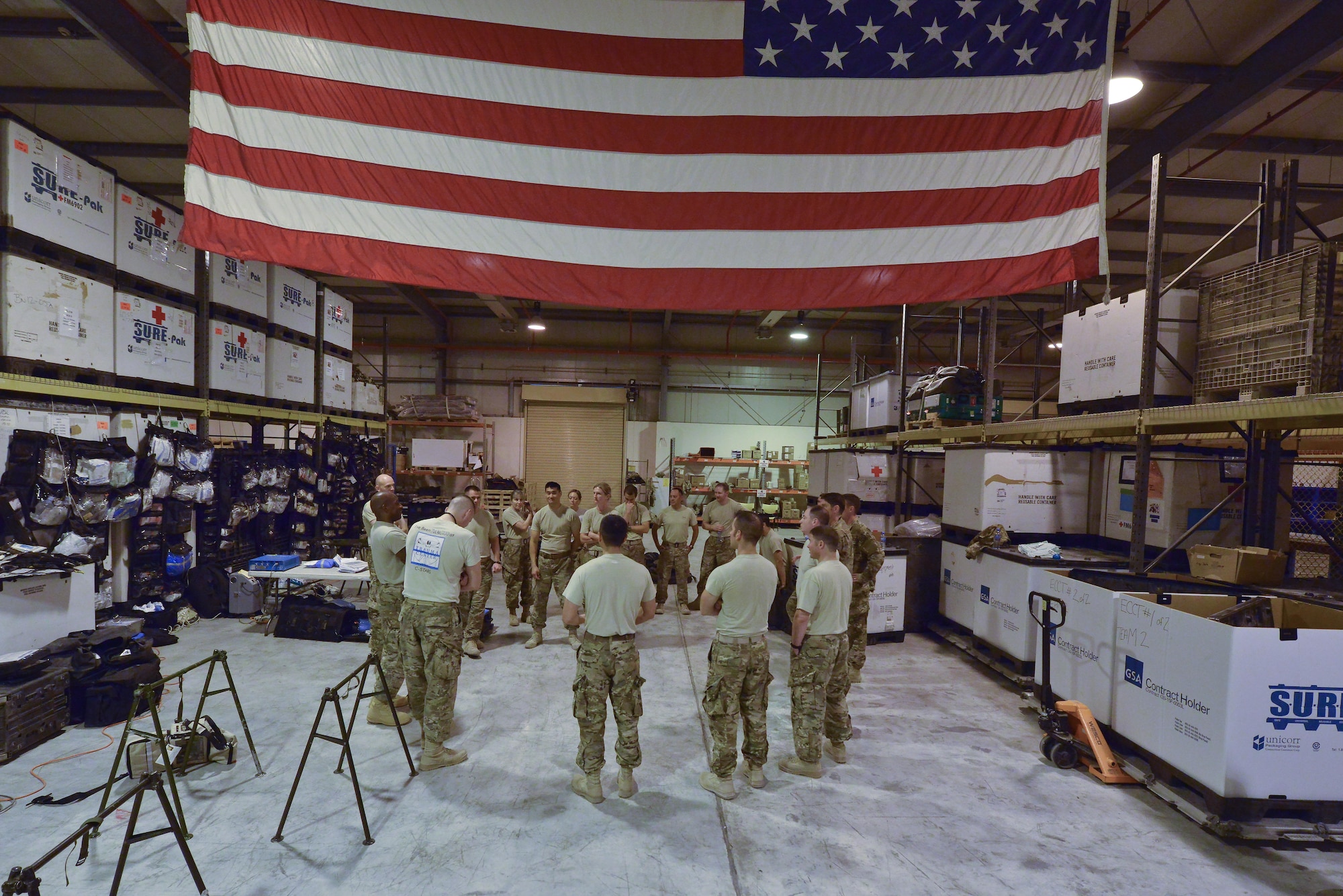 Airmen from the 379th Expeditionary Medical Group Mobile Field Surgical Team and Expeditionary Critical Care Team talk about the decisions and steps taken after a timed mobile hospital setup and equipment familiarization training August 28, 2015 at Al Udeid Air Base, Qatar. (U.S. Air Force photo/Staff Sgt. Alexandre Montes)  