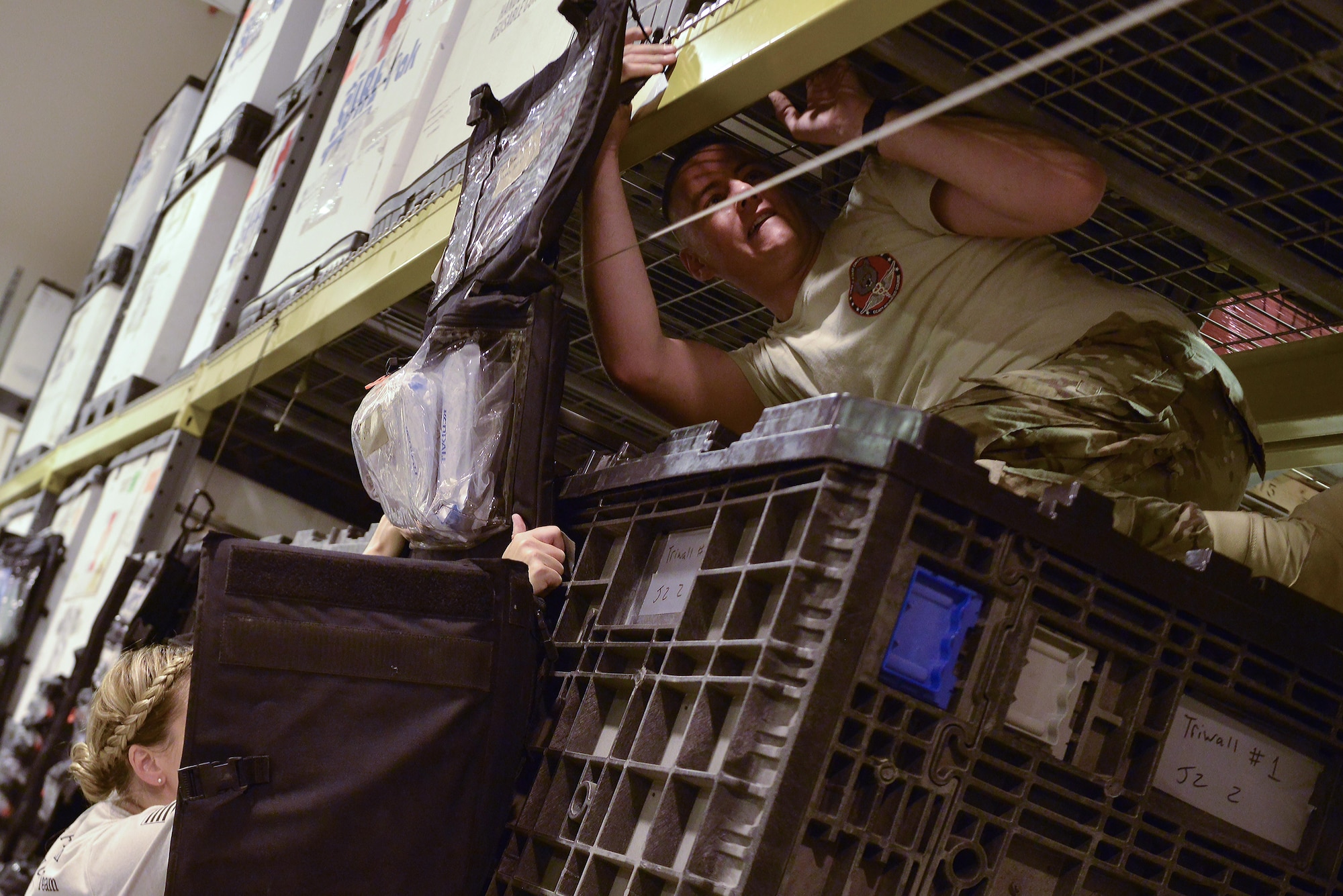 Capt. Suzanne Bohn and Staff Sgt. Cody Rothlisberger, 379th Expeditionary Medical Group Mobile Field Surgical Team, hang and secure their mobile Intensive Care supplies as they are timed during a setup and equipment familiarization training August 28, 2015 at Al Udeid Air Base, Qatar. (U.S. Air Force photo/Staff Sgt. Alexandre Montes)