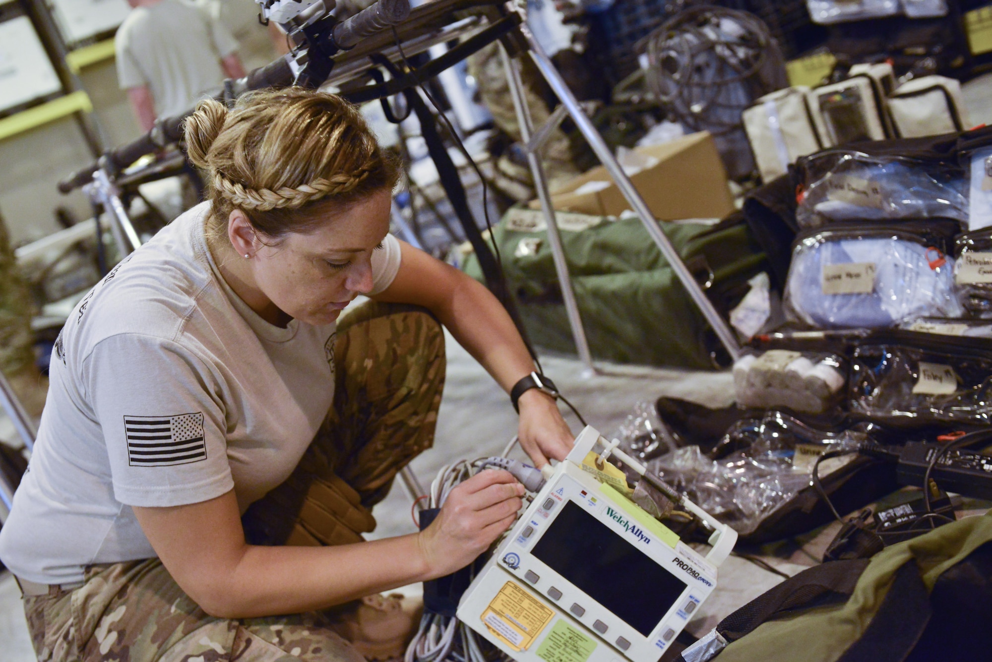 Capt. Suzanne Bohn, 379th Expeditionary Medical Group Mobile Field Surgical Team, completes a function check on a heart monitor in the intensive care section of the mobile hospital setup during a timed set up and equipment familiarization training August 28, 2015 at Al Udeid Air Base, Qatar. (U.S. Air Force photo/Staff Sgt. Alexandre Montes)