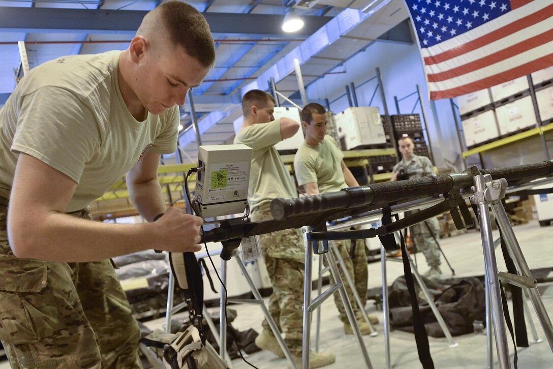 Staff Sgt. Cody Rothlisberger, 379th Expeditionary Medical Group Mobile Field Surgical Team, installs as blood pressure monitor to a stretcher in the intensive care section of the mobile hospital during a timed setup and equipment familiarization training August 28, 2015 at Al Udeid Air Base, Qatar. (U.S. Air Force photo/Staff Sgt. Alexandre Montes)