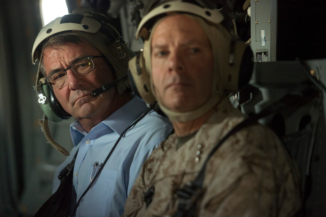 Defense Secretary Ash Carter listens to radio traffic as rides in a Marine Corps V-22 Osprey over Camp Pendleton Calif., Aug. 27, 2015. Carter visited the base to observe a beach assault demonstration and speak with Marines. DoD photo by U.S. Air Force Master Sgt. Adrian Cadiz
