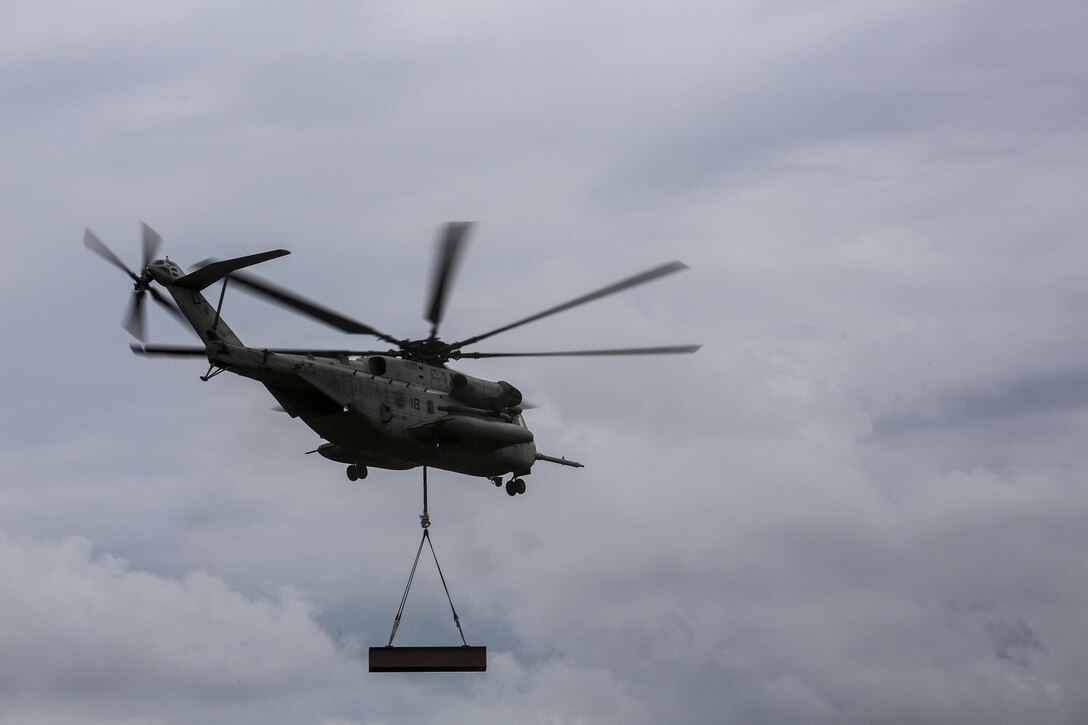 Marine pilots in a CH-53E Super Stallion with Marine Heavy Helicopter Training Squadron 302, carry away an 8,500-pound high beam during an external lifts exercise aboard Camp Lejeune, N.C., Aug. 25, 2015. The CH-53E completed a short circle pass, then slowly descended to allow Marines on the ground to disconnect the beam. (U.S. Marine Corps photo by Cpl. Paul S. Martinez/Released)