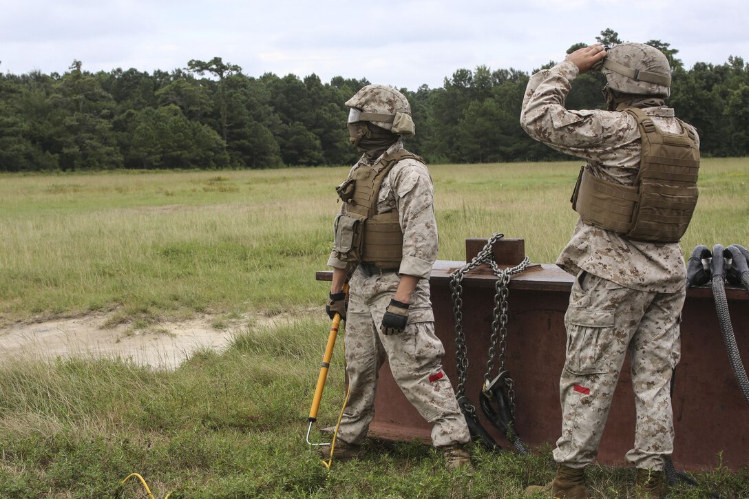 Marines with 2nd Transportation Support Battalion await the arrival of a CH-53E Super Stallion during an external lift exercise aboard Camp Lejeune, N.C., Aug. 25, 2015. As a CH-53E hovered several yards above, on-the-ground Marines worked together to attach a beam weighing 8,500 pounds to the aircraft’s cable. (U.S. Marine Corps photo by Cpl. Paul S. Martinez/Released)