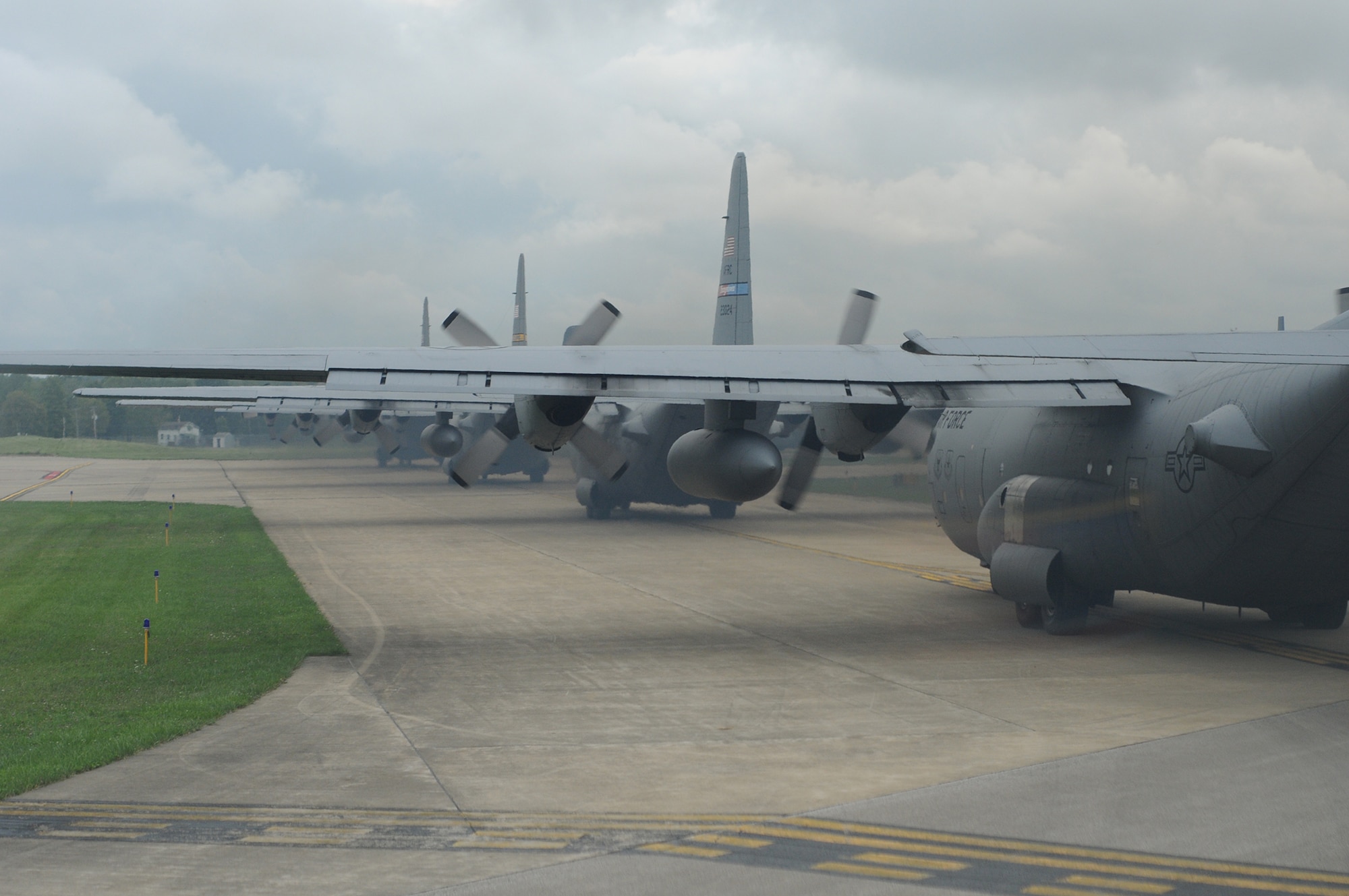 U.S. Air Force Reserve and Air National Guard C-130 cargo transport aircraft from Youngstown Air Reserve Station, Ohio, Dobbins Air Force Base, Georgia, Mansfield Lahm Air National Guard Base, Ohio, and Bradley Air National Guard Base, Connecticut, taxi down the ramp during a nine-aircraft formation training mission here, Aug. 27, 2015. The formation flew to a drop zone at Camp Ravenna, Ohio, to air drop palletized cargo and followed a tactical flight route through Ohio and Western Pennsylvania. The nine-ship formation was part of a C-130 Round-Up hosted by the 910th Airlift Wing. The Round-Up is a friendly skills competition for aircrew members and aerial porters, with events in cargo loading and unloading, aerial cargo drops, combat landings and formation flying. 