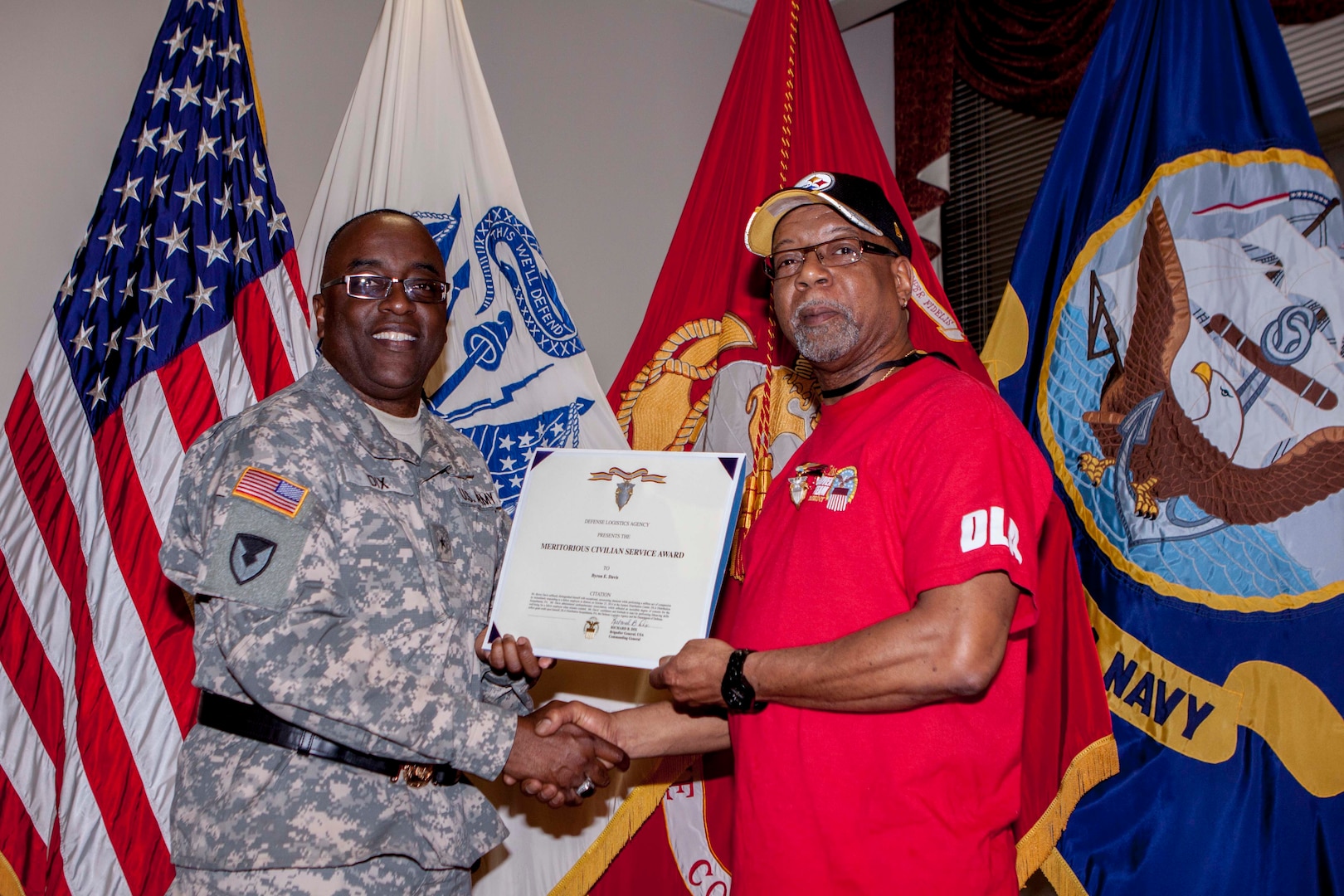 Byron Davis is presented the DLA Meritorious Service Award by DLA Distribution Commander Army Brig. Gen. Richard Dix for performing CPR on a co-worker exhibiting signs of a heart attack. 