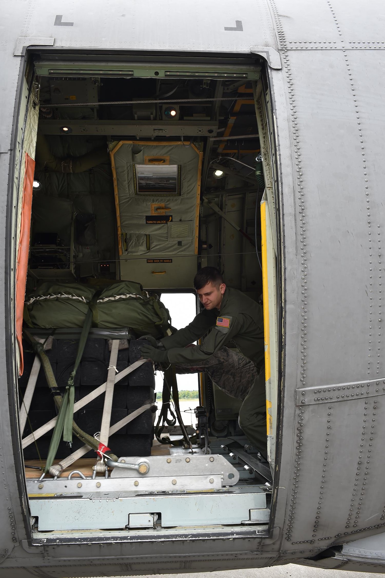 Senior Airman John Melnichenko, Loadmaster for the 757th Airlift Squadron here, guides a pallet onto an aircraft during the C-130 Round-Up here, Aug. 25. Events such as these are intended to test and enhance units’ abilities on areas such as cargo building, cargo drops, formation flying and other tactical flying maneuvers. (U.S. Air Force photo/Staff Sgt. Rachel Kocin)