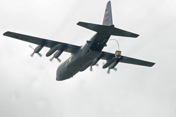 A cargo pallet is dropped from a C-130H Hercules aircraft over Camp Ravenna, Ohio Aug. 27, 2015. The aircraft was taking part in a nine C-130 formation training mission. The cargo drops were part of the C-130 Round-Up which took place Aug. 23-27. The Round-Up is a competition among airlift squadrons and aerial port squadrons which tests the capabilities of their airmen. (U. S. Air Force photo/ Tech. Sgt. Rick Lisum)