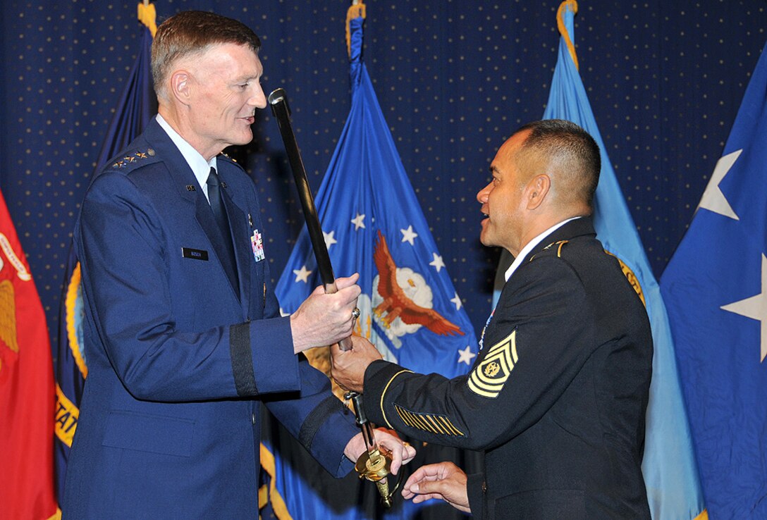Defense Logistics Agency Director Air Force Lt. Gen. Andy Busch passes the noncommissioned officer sword to Army Command Sgt. Maj. Charles M. Tobin, the incoming DLA senior enlisted leader, at the change of responsibility ceremony May 27 at the McNamara Headquarters Complex. 