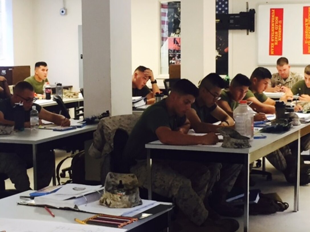 (Front Row) Pfcs. Phillips, Cheung, Zavala, and Pedrozagutierrez from BEEEST 8-15 learn about color coding portions of an A1 Backplane Module from Bravo Series, Tactical Quiet Generators (TQGs) taught by Sgt. Davenport at Marine Corps Engineer School, Camp Lejeune, N.C. August 24, 2015.  This task is one of seventeen the students must master in order to receive the 1142 Military Occupational Specialty (MOS).