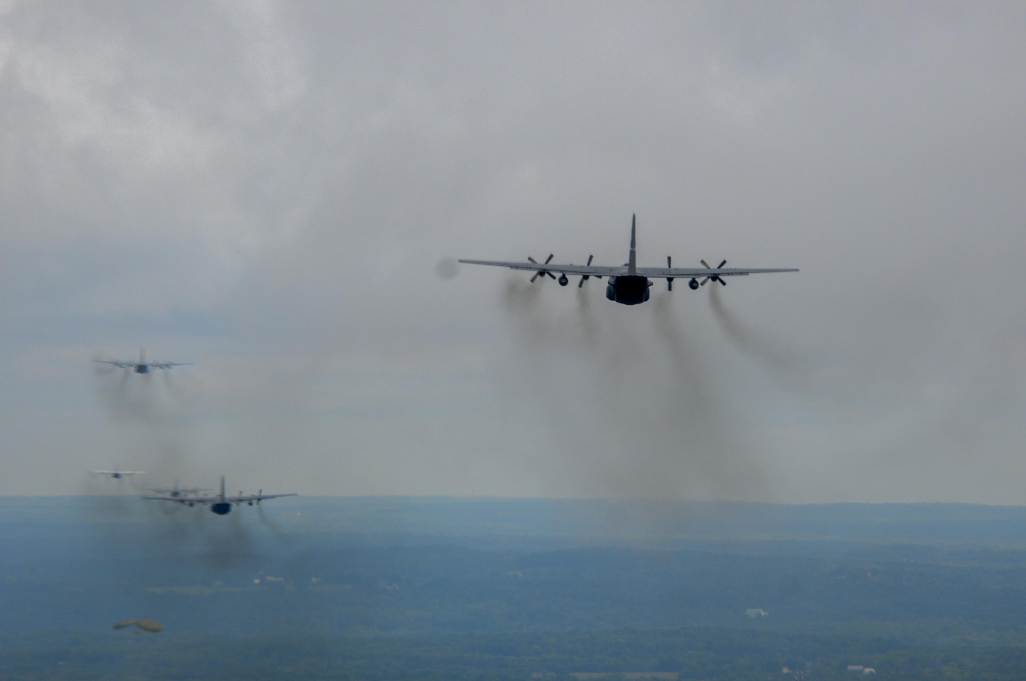 U.S. Air Force Reserve and Air National Guard C-130 cargo transport aircraft from Youngstown Air Reserve Station, Ohio, Dobbins Air Force Base, Georgia, Mansfield Lahm Air National Guard Base, Ohio, and Bradley Air National Guard Base, Connecticut, fly over Camp Ravenna preparing for cargo drops during a nine-aircraft formation training mission, Aug. 27, 2015. The nine-ship formation was part of a C-130 Round-Up hosted by the 910th Airlift Wing. The Round-Up is a friendly skills competition for aircrew members and aerial porters, with events in cargo loading and unloading, aerial cargo drops, combat landings and formation flying. (U.S. Air Force photo/Staff Sgt. Rachel Kocin)