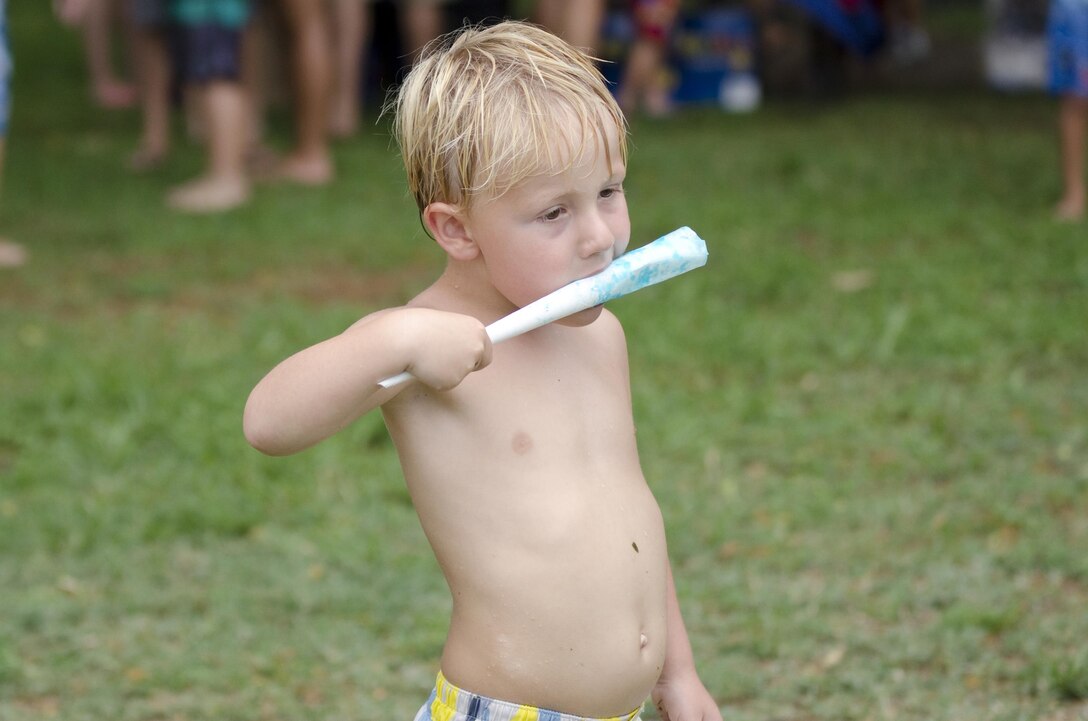 Ryan Tetreault finishes the last of his cotton candy during the Cub Scouts Pack 225 annual water roundup and membership event at Riseley Field aboard Marine Corps Base Hawaii, Aug. 22, 2015. “They’re a high quality unit,” said Richard Galluzzi, the district executive for the Boy Scouts of America Aloha Council. “I see all the good they do for both the kids (who) are involved and also the community. It makes me happy to come here and see how it benefits the community and the base (to have a Cub Scout pack). I think it’s a big asset.” The cub scouts do many different activities throughout the year, learning new skills, visiting new places and eventually moving up in rank in the Boy Scouts of America. The pack, which meets weekly, has many military children as members. Volunteers from Marine Corps Base Hawaii support the pack and the scouts, which helps the overall mission of the base, to take care of the families aboard the installation. (U.S. Marine Corps photo by Kristen Wong/Released)