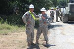 Soldiers from the 420th Engineer Brigade pose for a photograph while participating in a 25-day roadway construction project spanning 17 miles along the perimeter of the Camp Bowie Training Center in Brownwood from July 6-30, 2015. 