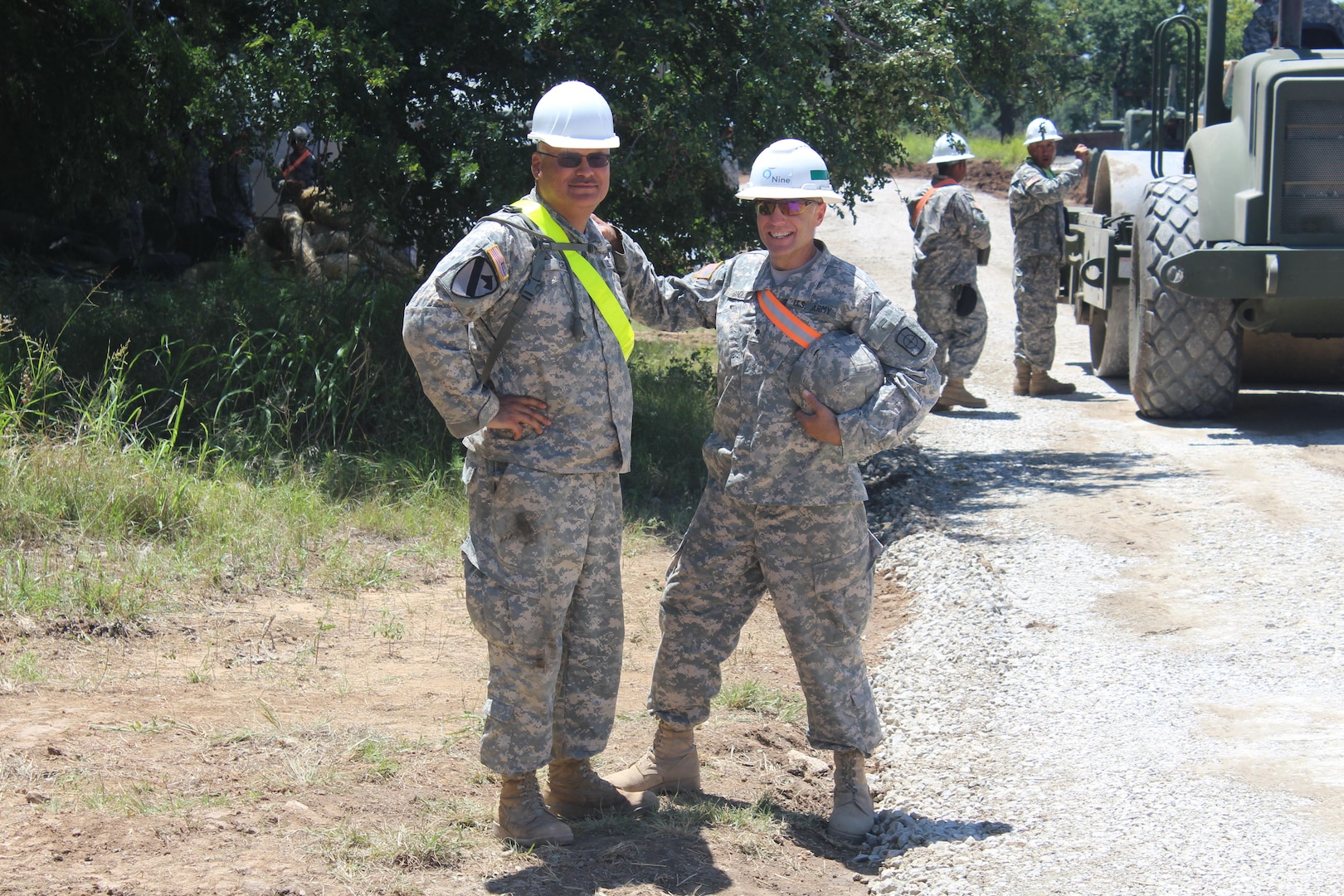 Soldiers from the 420th Engineer Brigade pose for a photograph while participating in a 25-day roadway construction project spanning 17 miles along the perimeter of the Camp Bowie Training Center in Brownwood from July 6-30, 2015. 