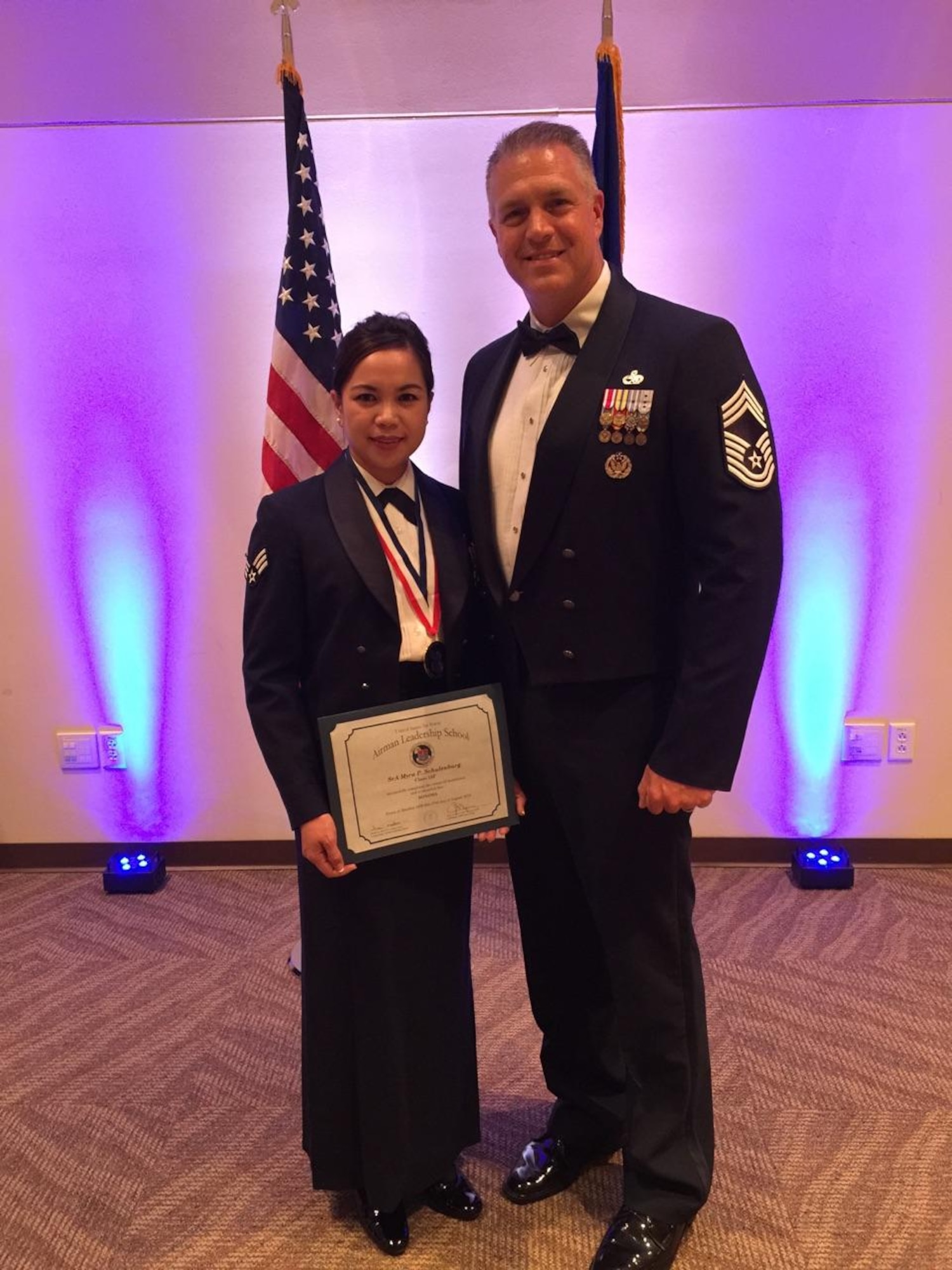 Chief Master Sgt. Sean Strong, Air Reserve Personnel Center Total Force Service Center superintendent, stands with Senior Airman Myra Schulenburg, ARPC contact center counselor, after the Buckley Airman Leadership School Class 15-F graduation at the Leadership Development Center Aug. 27, 2015, on Buckley Air Force Base, Colo. This graduation represents an important part of the enlisted force professional military education, teaching valuable skills required for supervisors. (U.S. Air Force photo by Airman 1st Class Luke W. Nowakowski)