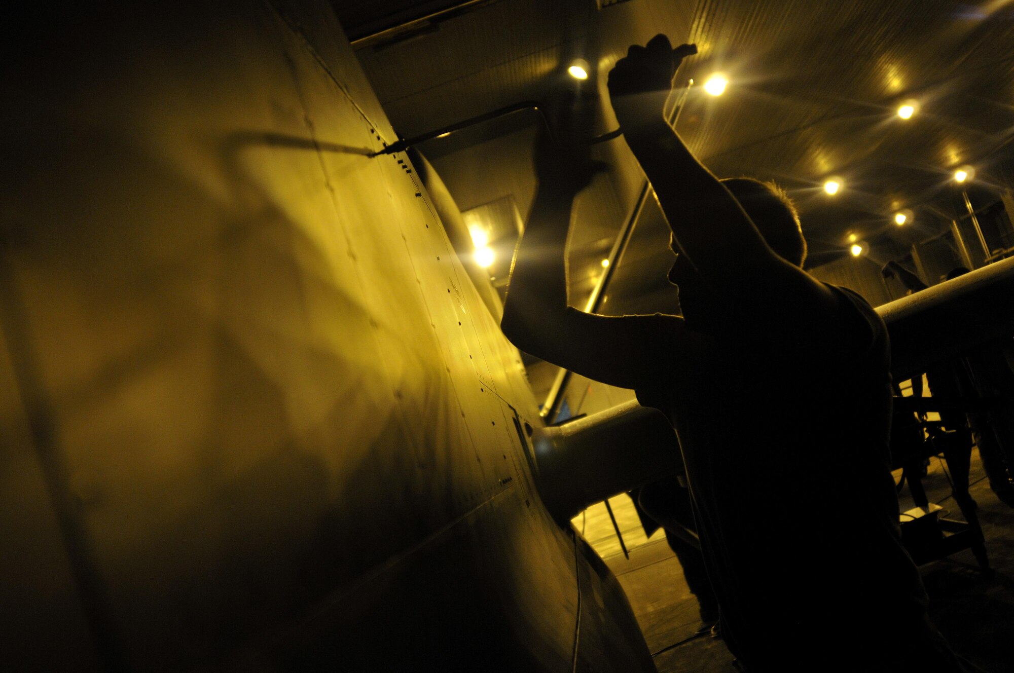 A maintainer from the 69th Maintenance Squadron uses a wrench to unscrew a panel on a RQ-4 Global Hawk during a flight recovery operation at Misawa Air Base, Japan, Aug. 19, 2015. Approximately 40 personnel are deployed here to provide flight and support operations during the unmanned aircraft’s scheduled rotation. (U.S. Air Force photo by Senior Airman Jose L. Hernandez-Domitilo/Released)