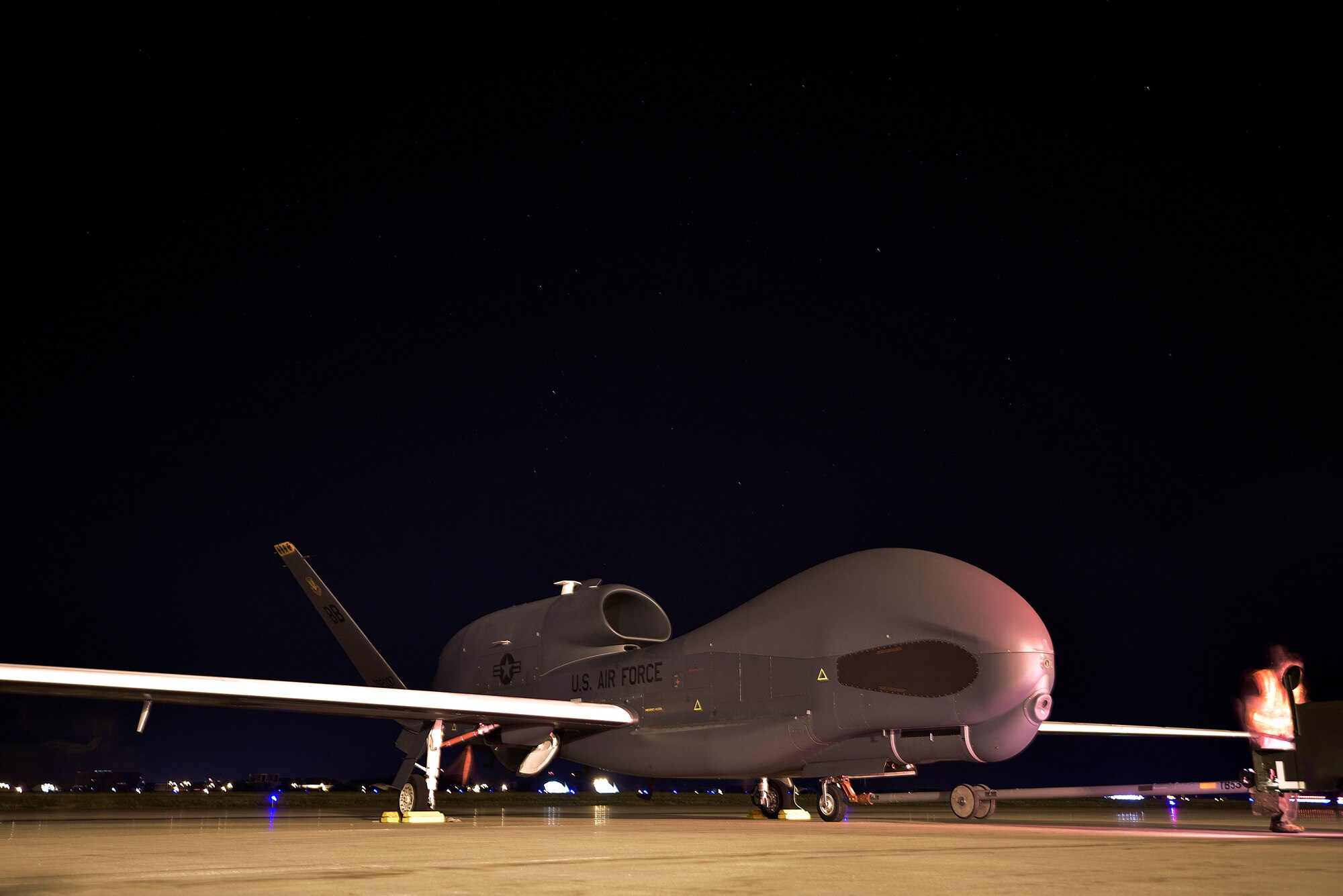An RQ-4 Global Hawk is towed during flight recovery at Misawa Air Base, Japan, Aug. 19, 2015. Several of these unmanned aircraft will operate out of Misawa until December 2015, and will provide a broad spectrum of intelligence, surveillance and reconnaissance collection capabilities in support of joint combatant forces in worldwide peacetime, contingency and crisis operations. (U.S. Air Force photo by Senior Airman Jose L. Hernandez-Domitilo/Released)