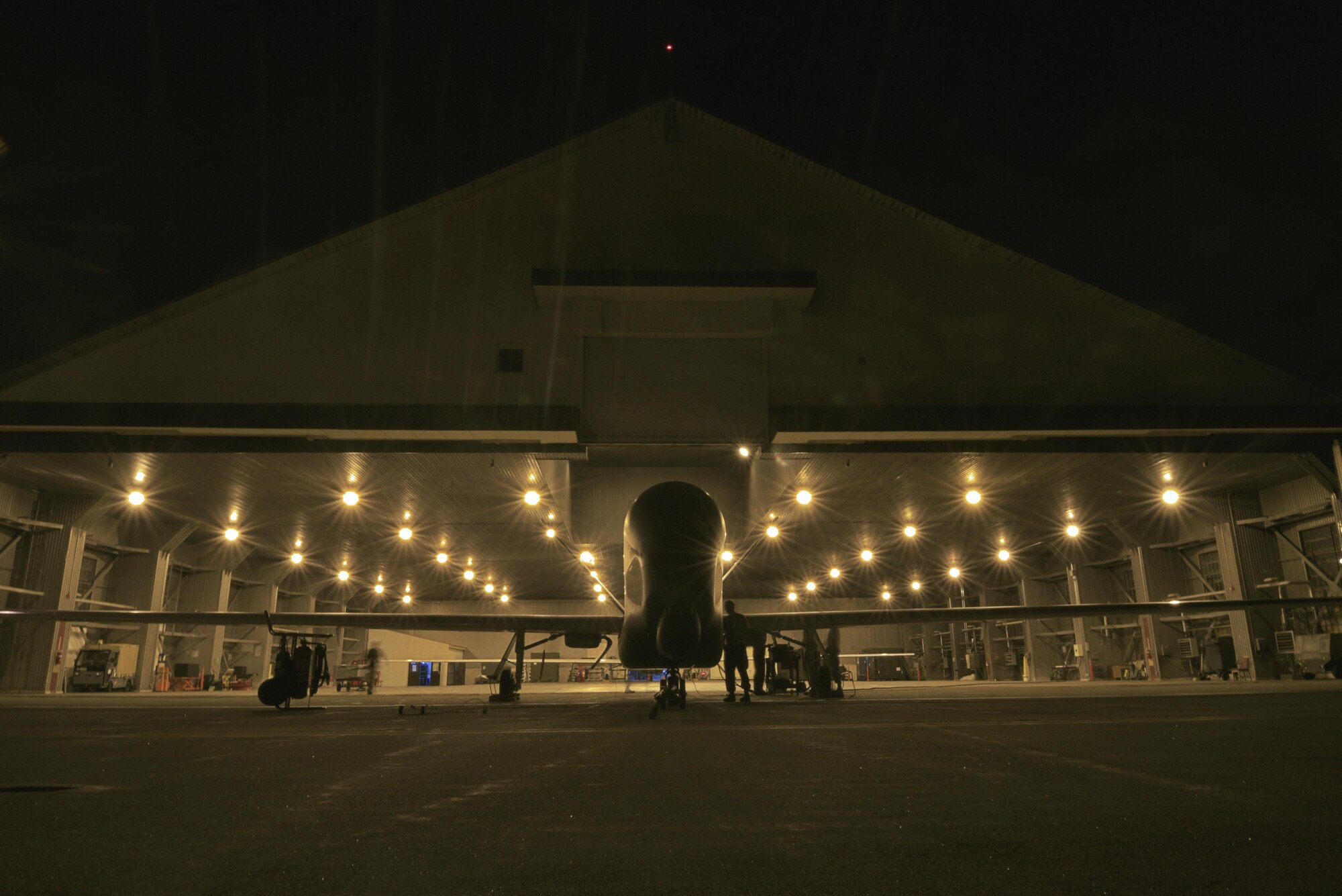 Maintainers from the 69th Maintenance Squadron perform an operations check on a RQ-4 Global Hawk at Misawa Air Base, Japan, Aug. 19, 2015. Before and after every RQ-4 flight, maintainers conduct an operations check and a 360-degree assessment of the unmanned aircraft to ensure there are no discrepancies. (U.S. Air Force photo by Senior Airman Jose L. Hernandez-Domitilo/Released)