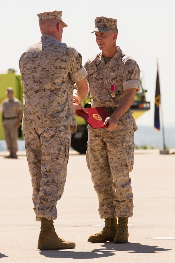 Col. John Farnam, former commanding officer of Marine Corps Air Station Miramar, California, recieves the Legion of Merit from Brig. Gen. Edward Banta, commanding general of Marine Corps Installations West, during a change of command ceremony aboard the air station, Aug. 28. The change of command also marks the end of Farnam's approximately 25 years of active service in the Marine Corps. 