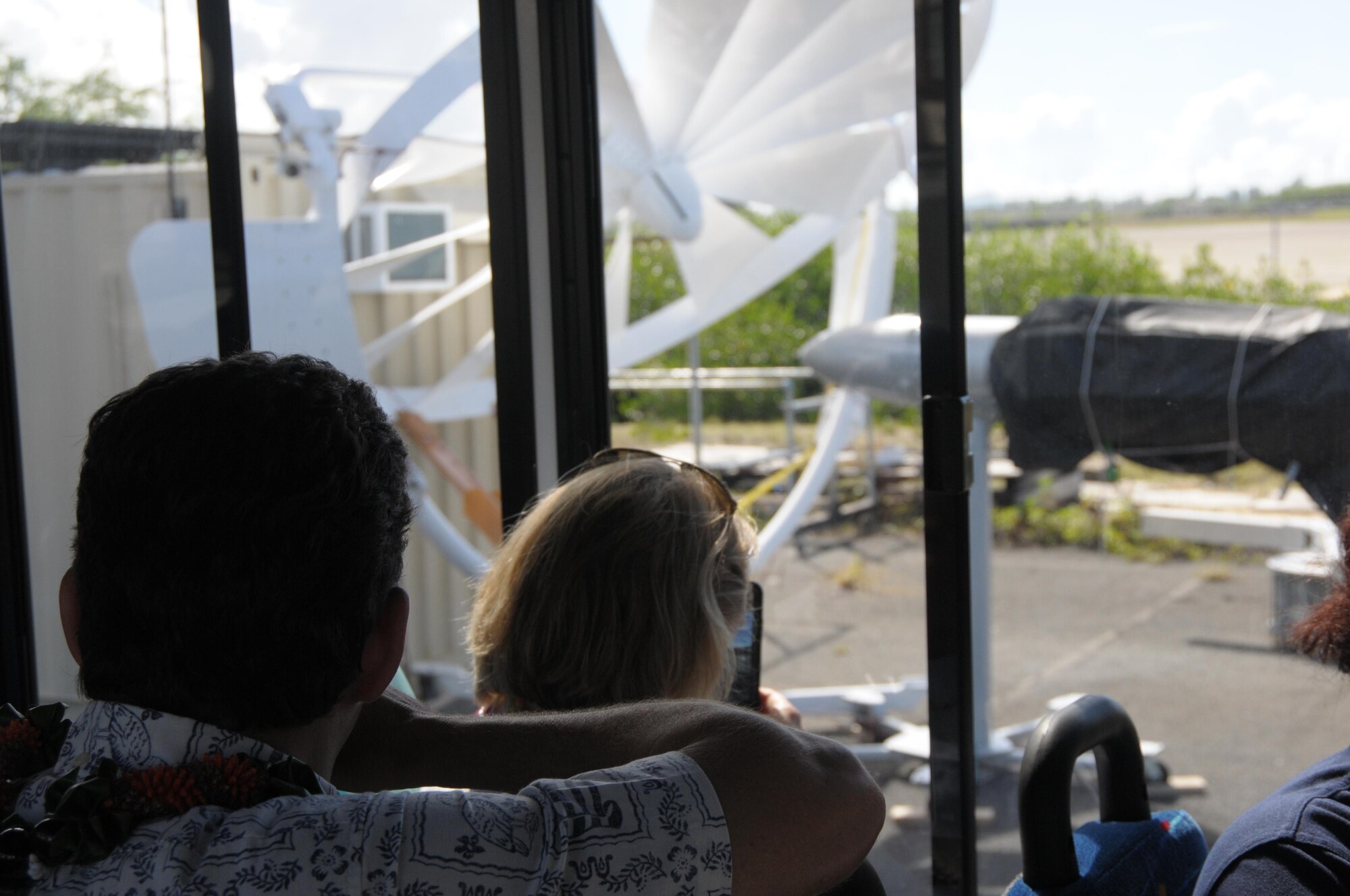 U.S. Sen. Brian Schatz and Miranda A. Ballentine, assistant secretary of the Air Force for Installations, Environment, and Energy, view a spoke wheel medium wind power system during a tour of the Air Force Energy Security Integration and Demonstration Center, Aug. 26, 2015, at Joint Base Pearl Harbor-Hickam. The objective of the center is to establish the first Air Force integrated energy test bed to demonstrate the best energy solution in response to operational demands. (U.S. Air National Guard photo by Senior Master Sgt. Kristen Stanley /released)