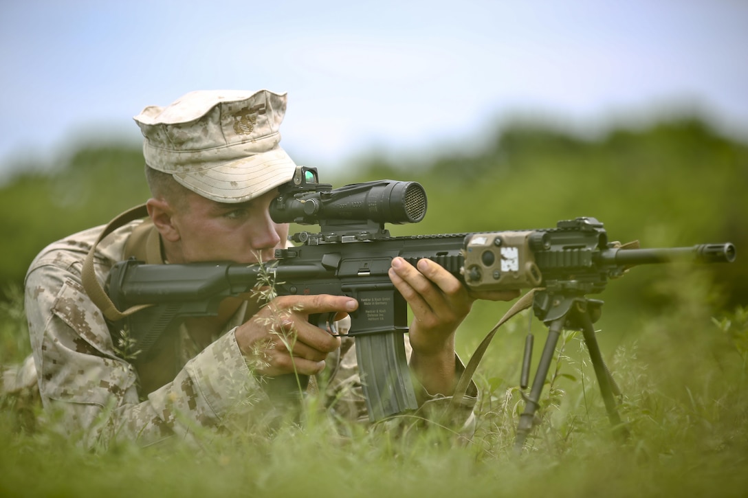 Lance Cpl. Joshua Behling, a team leader with India Company, 3rd Battalion, 3rd Marines, and De Pere, Wis., native, provides security from the prone position during signal, tactics and maneuver training at Boondocker Training Area aboard Marine Corps Base Hawaii, Aug. 24, 2015. The purpose of the training was to prepare the company’s Marines at the squad level, ensuring they are able to efficiently and effectively perform squad attacks and movements. By preparing their Marines for a combat environment, 3rd Bn., 3rd Marines, helps support the mission of MCB Hawaii, which is to enhance and sustain combat readiness for all operating forces and tenant organizations aboard the installation. (U.S. Marine Corps photo by Lance Cpl. Harley Thomas/Released)