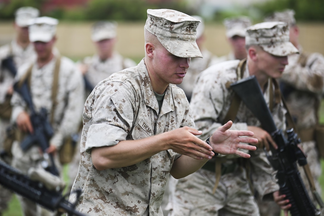 U.S. Marine Corps 2nd Lt. William Thompson, the officer in charge with India Company, 3rd Battalion, 3rd Marine Regiment, and Shelbyville, Ky., native, briefs Marines during signal, tactics and maneuver training at Boondocker Training Area aboard Marine Corps Base Hawaii, Aug. 24, 2015. The purpose of the training was to prepare the company’s Marines at the squad level, ensuring they are able to efficiently and effectively perform squad attacks and movements. By preparing their Marines for a combat environment, 3rd Bn., 3rd Marines, helps support the mission of MCB Hawaii, which is to enhance and sustain combat readiness for all operating forces and tenant organizations aboard the installation. (U.S. Marine Corps photo by Lance Cpl. Harley Thomas/Released)