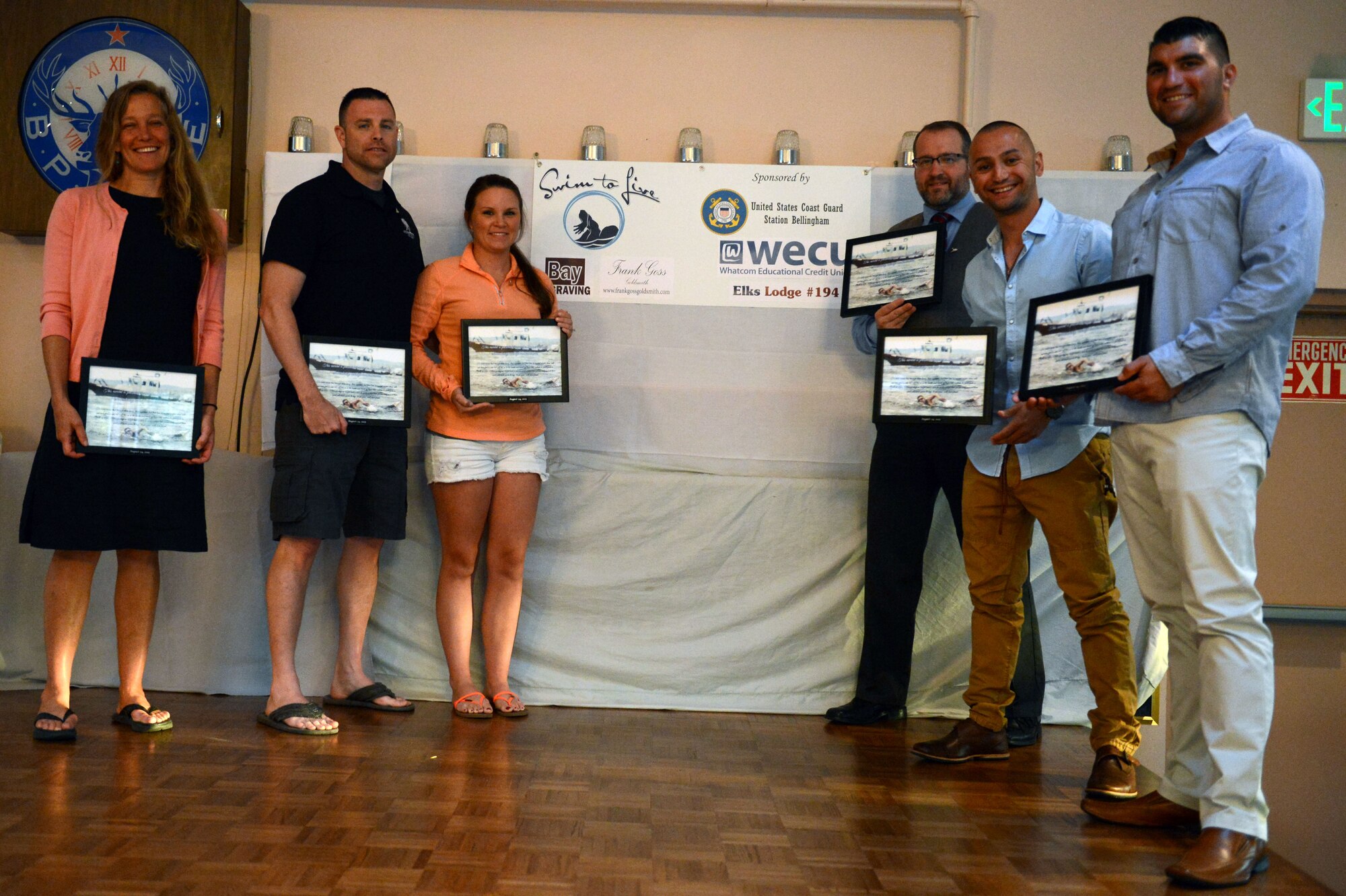 Swimmers from the Swim to Live event pose for a photo with their recognition certificates from the Josh Fueston Memorial Foundation in Bellingham, Wash., Aug. 24, 2015. The certificate the swimmers received reads, “To make aware that through these living, these ones who lost their lives to combat related stress will not have died in vain but will live on in the hearts and minds of those who continue to participate in Swim to Live. Although they no longer have a voice to speak, a hope that for one brief moment their spirit will touch yours to say ‘thank you,’ well done friend.” (U.S. Air Force photo/Staff Sgt. Katie Jackson)