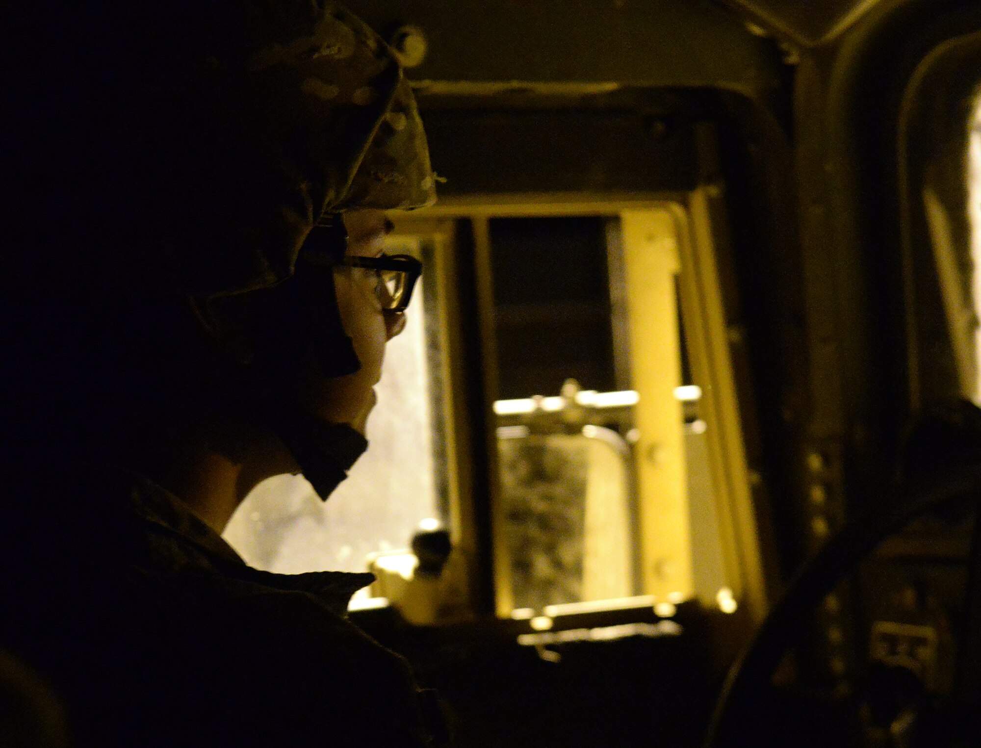 A 790th Missile Security Forces Squadron Airman drives a Humvee through a missile alert facility front gate at approximately 11 p.m. Aug. 20, 2015. Missile cops perform security checks of launch facilities day and night to ensure a safe and secure missile field. (U.S. Air Force photo by Airman 1st Class Brandon Valle)