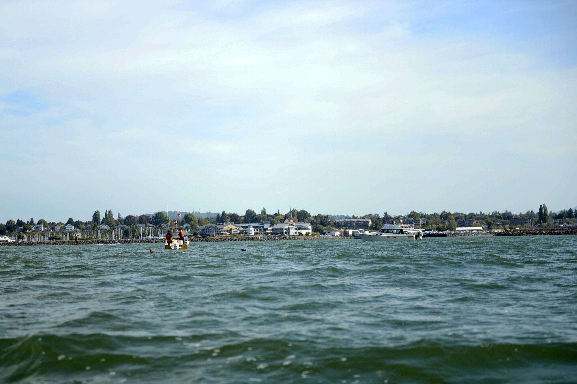 Senior Airman Zavki Omonov (left), 627th Security Forces Squadron command support staff, and Amy Sothman (right), swim the last two miles of the four mile Swim to Live relay in the Bellingham Bay, Wash., Aug. 24, 2015. At the marker for the final mile of the swim, the remaining six swimmers jumped in to complete the relay together while family, friends, and onlookers cheered them on from the shoreline. (U.S. Air Force photo/Staff Sgt. Katie Jackson)