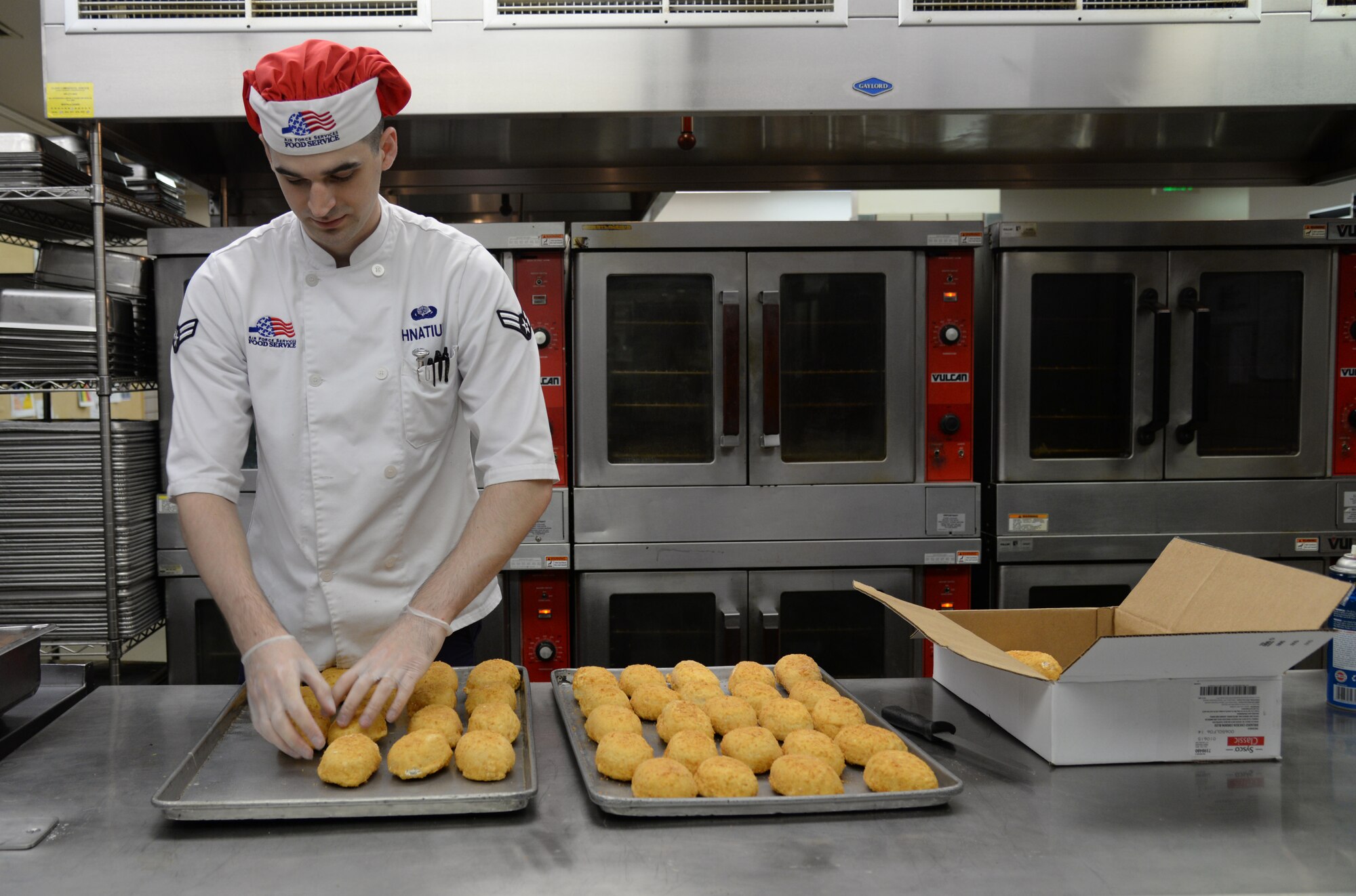 U.S. Air Force Airman 1st Class Jeremy P. Hnatiuk, a 354th Force Support Squadron shift leader, prepares chicken to be cooked in the Two Seasons Dining Facility, Aug. 27, 2015, at Eielson Air Force Base, Alaska. Hnatiuk prepares food on a daily basis to serve to Airmen for breakfast, lunch and dinner. (U.S. Air Force photo by Airman 1st Class Cassandra Whitman/Released)