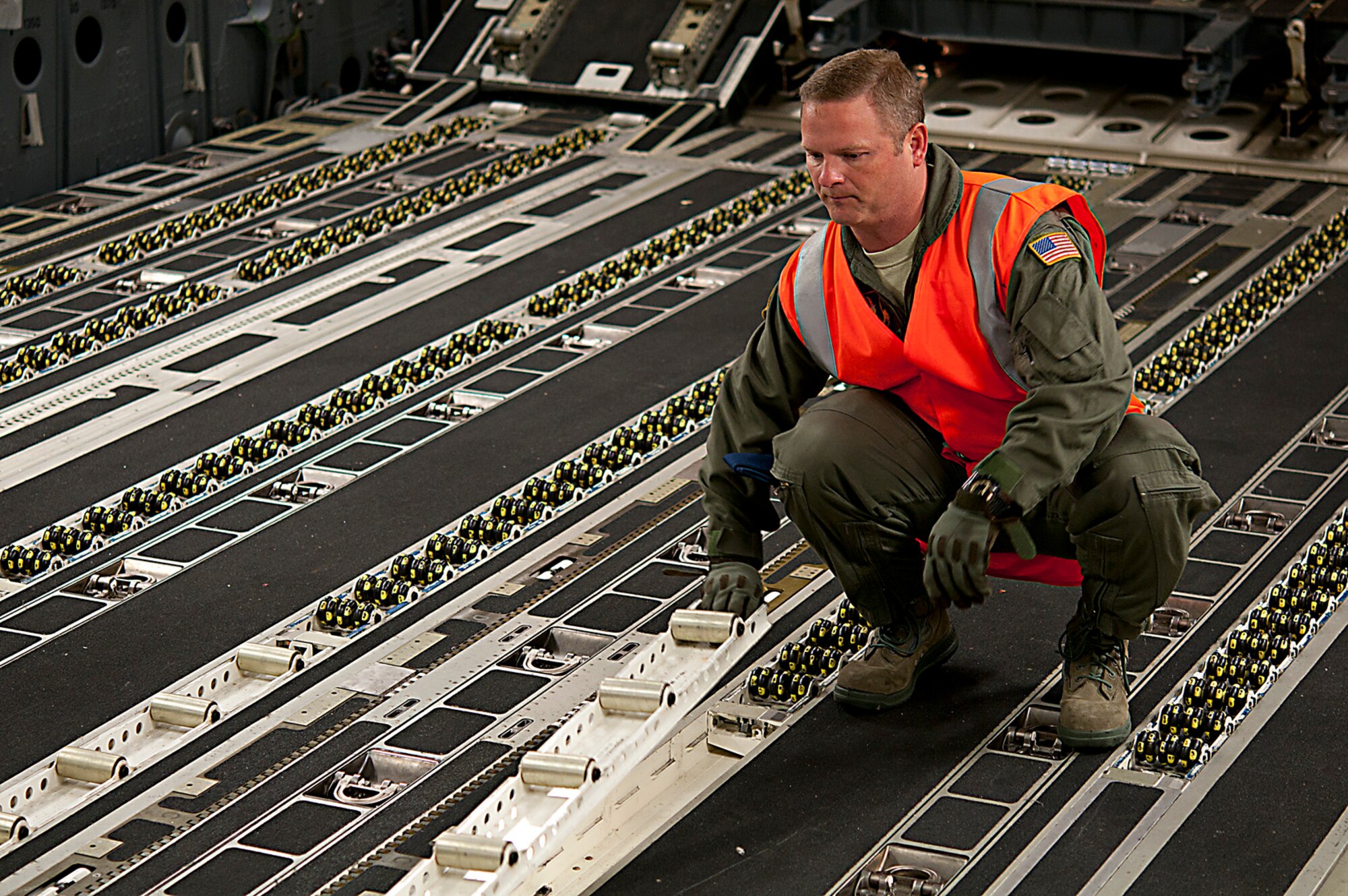 U.S. Air Force Master Sgt. Thomas Emmert, 304th Expeditionary Airlift Squadron loadmaster, prepares a U.S. Air Force C-17 Globemaster III for cargo at Christchurch International Airport, New Zealand, Aug. 21, 2015, in support of the U.S. Antarctic Program’s WINFLY. The rollers sometimes freeze after the five hour flight to Antarctica and can make it difficult for loadmasters to unload cargo. (U.S. Air Force photo by Senior Airman Madelyn McCullough)