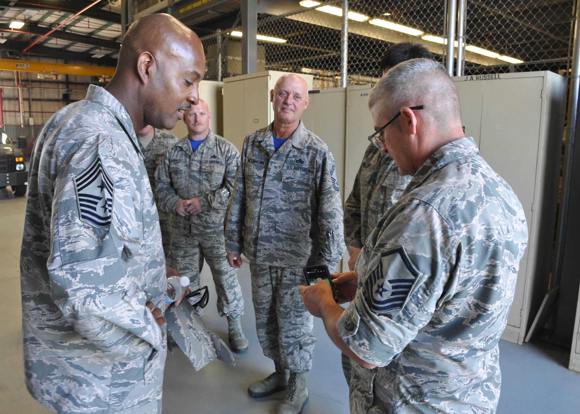 AFRC Command Chief Cameron B. Kirksey checks out photos with Master Sgt. David L. Wallis, an engine mechanic with the 507th Aircraft Maintenance Squadron during a three-day tour of the 507th Air Refueling Wing August 9, 2015, at Tinker Air Force Base, Okla. Kirksey has visited more than 20 Reserve units during his tenure as command chief. (U.S. Air Force photo by Staff Sgt. Lauren Gleason)




