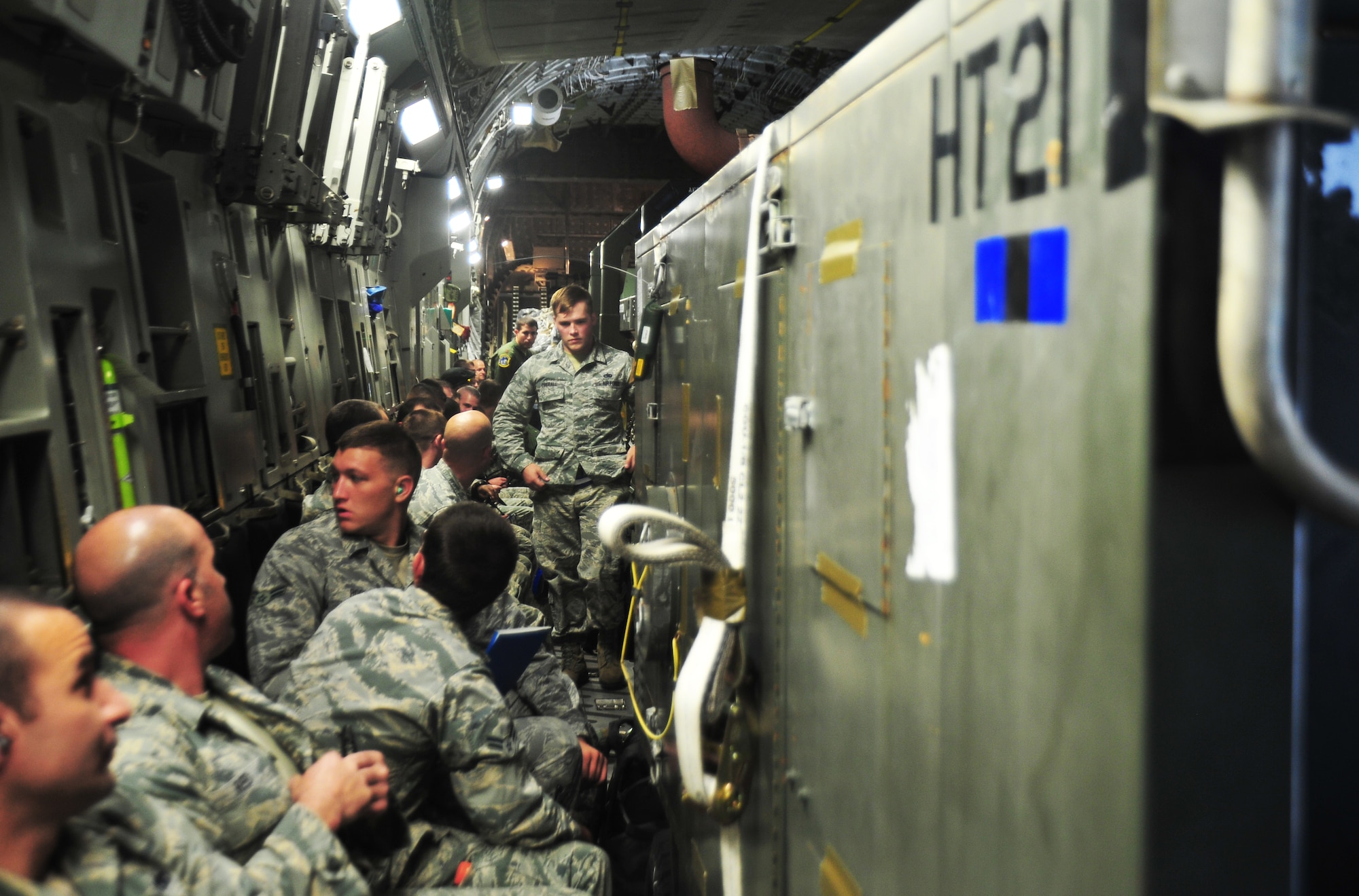 Airmen and cargo from Tyndall Air Force Base, Fla. pack into a C-17 Globemaster III as it taxies on the Tyndall flightline. The supplies and Airmen will be part of the first-ever F-22 Raptor deployment to Europe that will allow for F-22 pilots to train alongside joint partners, NATO allies and other U.S. Air Force aircraft. (U.S. Air Force photo by Airman 1st Class Dustin Mullen/Released)