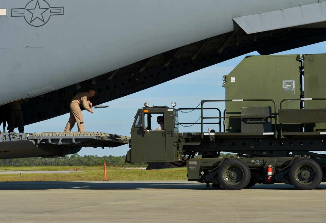 Tyndall Airmen load a C-17 Globemaster III with cargo necessary for the first-ever F-22 training deployment to Europe at Tyndall. The deployment is in direct support to the European Reassurance Initiative and will allow for F-22 pilots to train alongside joint partners, NATO allies and other U.S. Air Force aircraft. (U.S. Air Force photo by Tech. Sgt. Javier Cruz/Released)