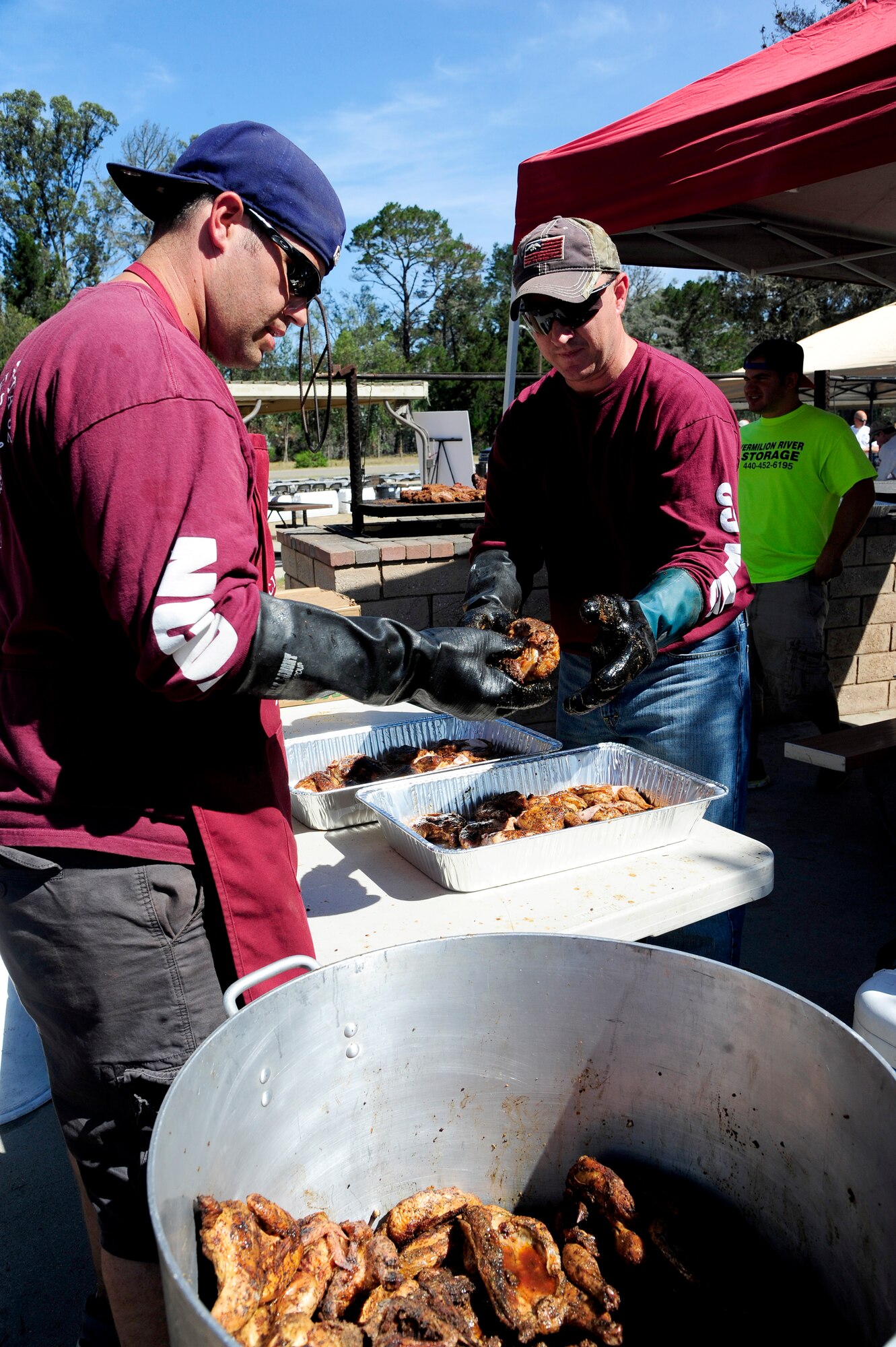 Staff Sgt. Jeff Pirnat, left, 614th Air and Space Communications Squadron knowledge management technician, and Master Sgt. Shane Wright, 576th Flight Test Squadron NCO in charge of missile handling section, prepare chicken for the annual military appreciation barbeque, Aug. 28, 2015, on Vandenberg Air Force Base, Calif. Further strengthening an already robust relationship between the city of Lompoc and Vandenberg, the barbeque was prepared by the Noncommissioned Officers Association. (U.S. Air Force photo by Senior Airman Kyla Gifford/Released)