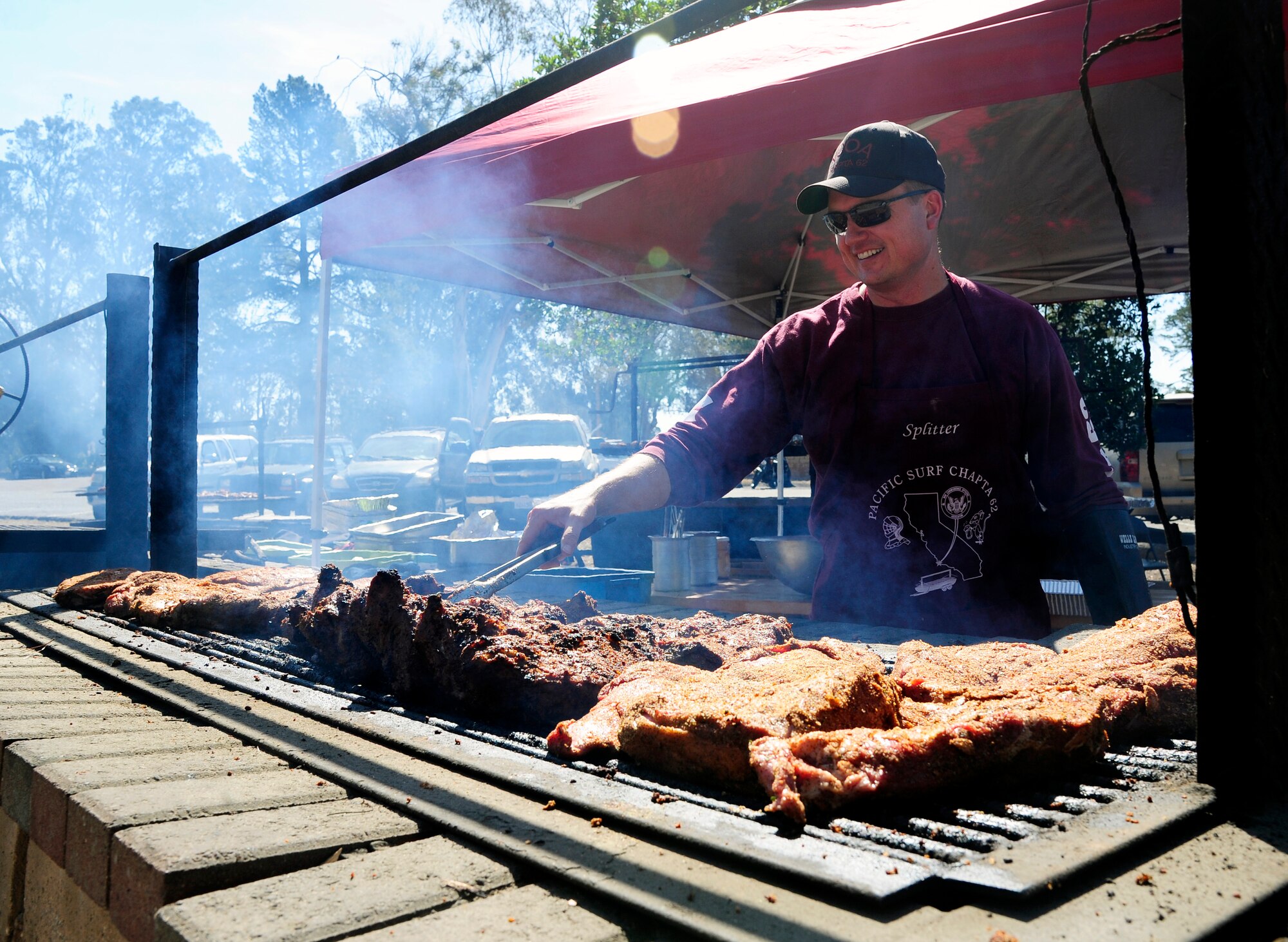 Master Sgt. David Bohlander, 576th Flight Test Squadron missile systems chief, grills tri-tip steak during the annual military appreciation barbeque, Aug. 28, 2015, on Vandenberg Air Force Base, Calif. The free event was organized by the Military Affairs Committee of Lompoc and has been an annual occurrence for decades. (U.S. Air Force photo by Senior Airman Kyla Gifford/Released)