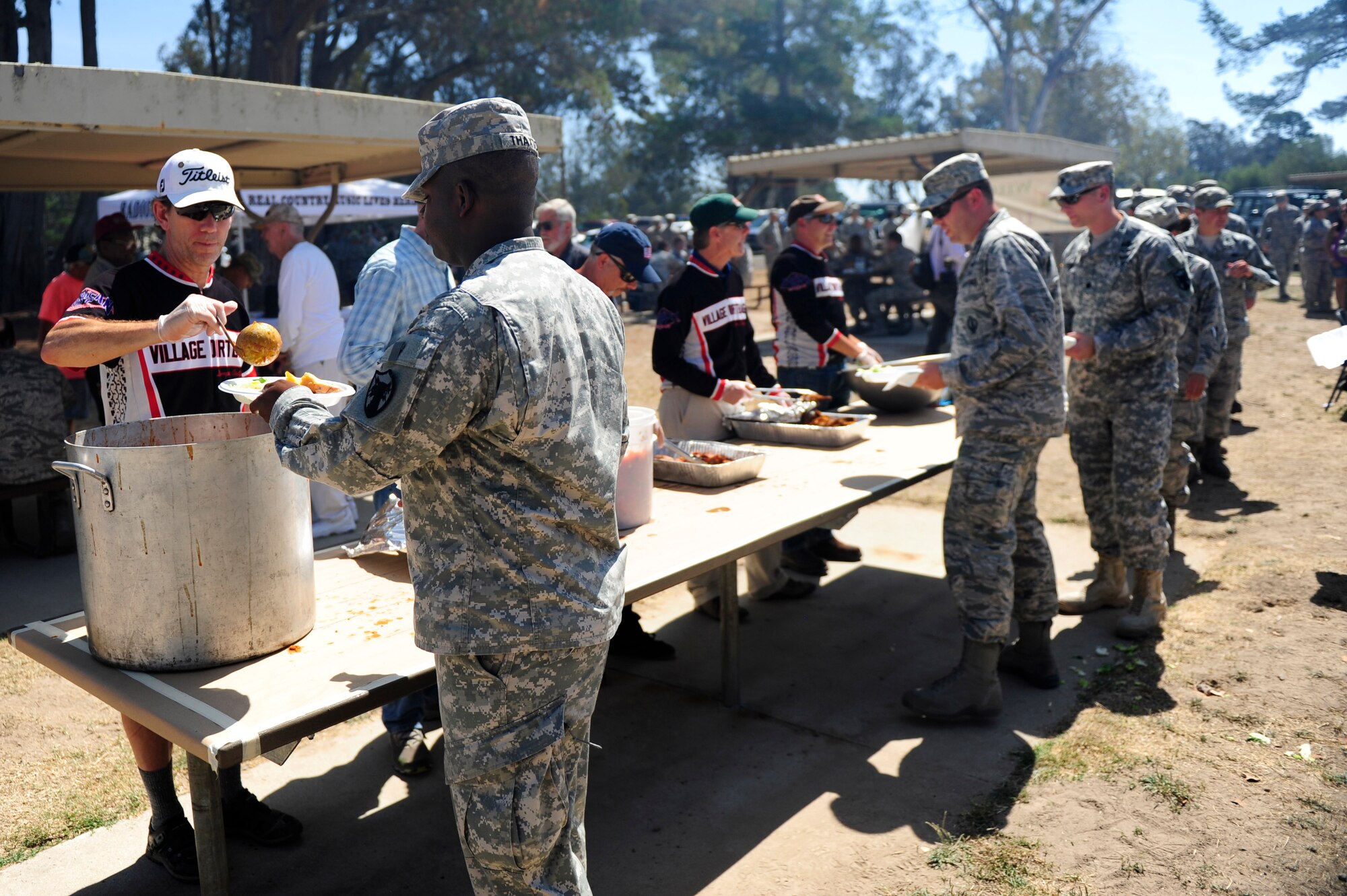The Village Dirtbags serve barbeque to Team Vandenberg during a military appreciation barbeque, Aug. 28, 2015, Vandenberg Air Force Base, Calif. The free event was organized by the Military Affairs Committee of Lompoc and has been an annual occurrence for decades. (U.S. Air Force photo by Staff Sgt. Jim Araos/Released)