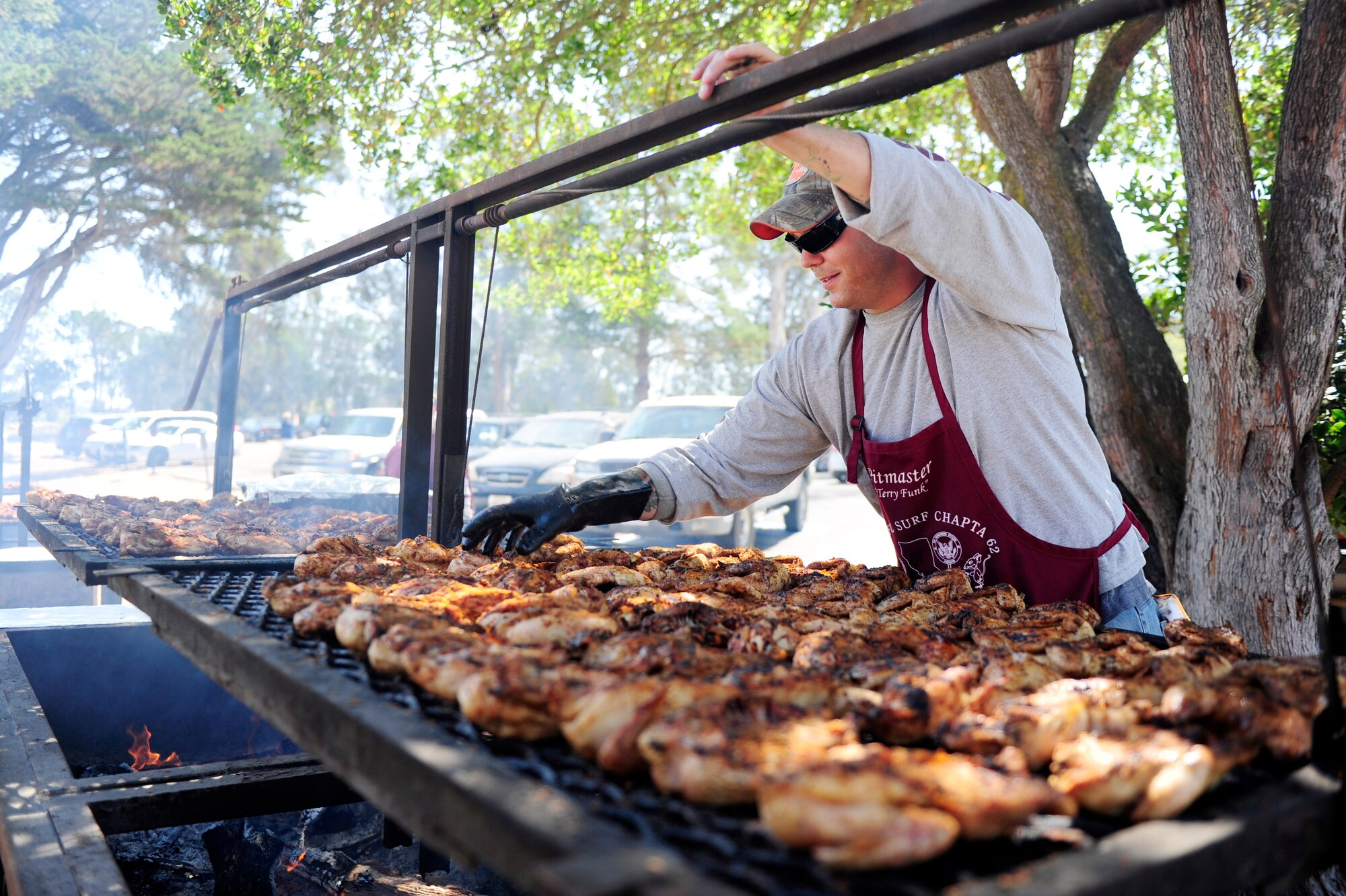 Staff Sgt. Scott Morgan, 1st Air and Space Test Squadron spacelift maintenance technician, cooks during a military appreciation barbeque, Aug. 28, 2015, Vandenberg Air Force Base, Calif.  The free event was organized by the Military Affairs Committee of Lompoc and has been an annual occurrence for decades. (U.S. Air Force photo by Staff Sgt. Jim Araos/Released)