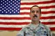 Master Sgt. Charles Keller, 433rd Aircraft Maintenance Squadron flying crew chief, poses in front of an American flag in his office Aug. 28, 2015 at Joint Base San Antonio-Lackland, Texas. Ten years ago MSgt. Keller supported the evacuation and transport of evacuees during Hurricane Katrina. Aircraft Maintenance specialists are responsible for ensuring everything from tip to tail is maintained on the aircraft. (U.S. Air Force photo by SrA Bryan Swink)(released)
