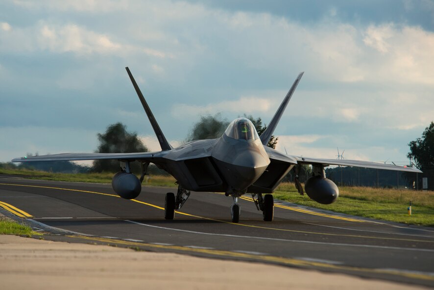 An F-22 Raptor fighter aircraft pilot assigned to the 95th Fighter Squadron at Tyndall Air Force Base, Fla., taxis to a hardened aircraft shelter at Spangdahlem Air Base, Germany, Aug. 28, 2015. The U.S. Air Force deployed four F-22 Raptors, one C-17 Globemaster III and more than 50 Airmen to Spangdahlem in support of the first F-22 European training deployment. The inaugural F-22 training deployment to Europe is funded by the European Reassurance Initiative, a $1 billion pledge announced by President Obama in March 2014.(U.S. Air Force photo by Airman 1st Class Luke Kitterman/Released)