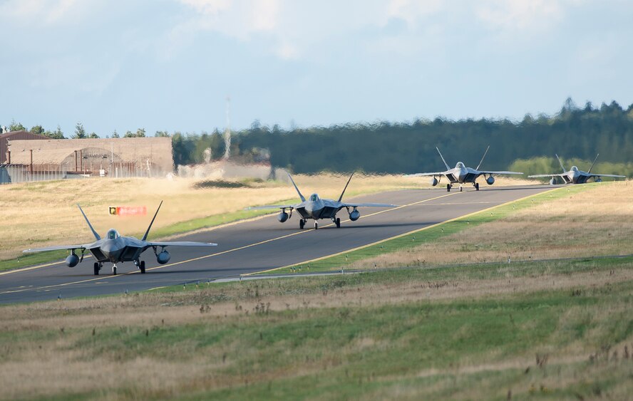 Four F-22 Raptor fighter aircraft taxi after landing at Spangdahlem Air Base, Germany, Aug. 28, 2015 as part of the inaugural F-22 training deployment to Europe. The F-22s are deployed from the 95th Fighter Squadron at Tyndall Air Force Base, Fla., as part of the European Reassurance Initiative and will conduct air training with other Europe-based aircraft while demonstrating U.S. commitment to NATO allies and the security of Europe. (U.S. Air Force photo by Staff Sgt. Chad Warren/Released)