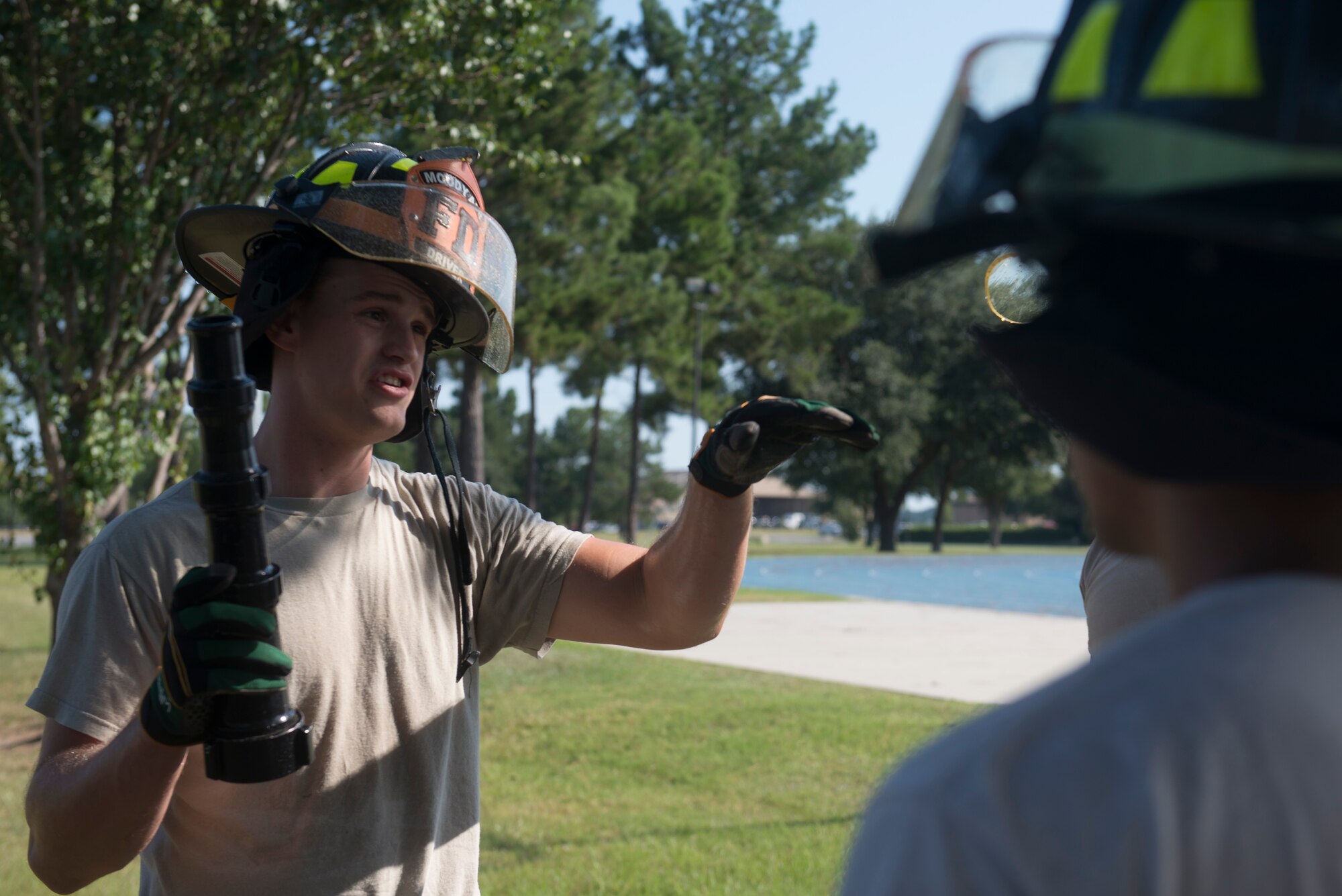 U.S. Air Force Senior Airman Cody Jones, 23d Civil Engineer Squadron fire protection journeyman, discusses the use of a smooth boar tip during pump operations training Aug. 27, 2015, at Moody Air Force Base, Ga. Moody firefighters use this tip on their high-pressure water pumps to apply direct streams of water to eliminate fires. (U.S. Air Force Airman 1st Class Dillian Bamman/Released)