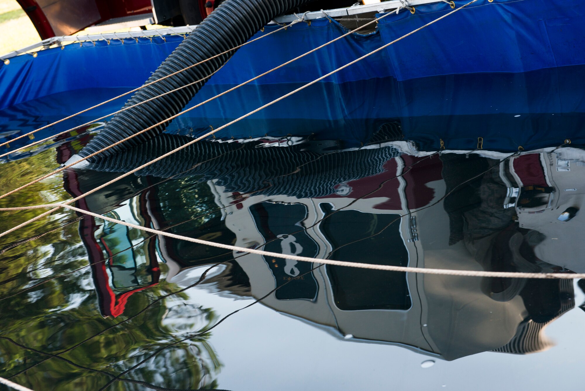 A draft tank rests beside a 23d Civil Engineer Squadron fire truck during pump operations training Aug. 27, 2015, at Moody Air Force Base, Ga. The tank operates as a deployable fire hydrant when water isn’t readily accessible for fire protection. (U.S. Air Force Airman 1st Class Dillian Bamman/Released)