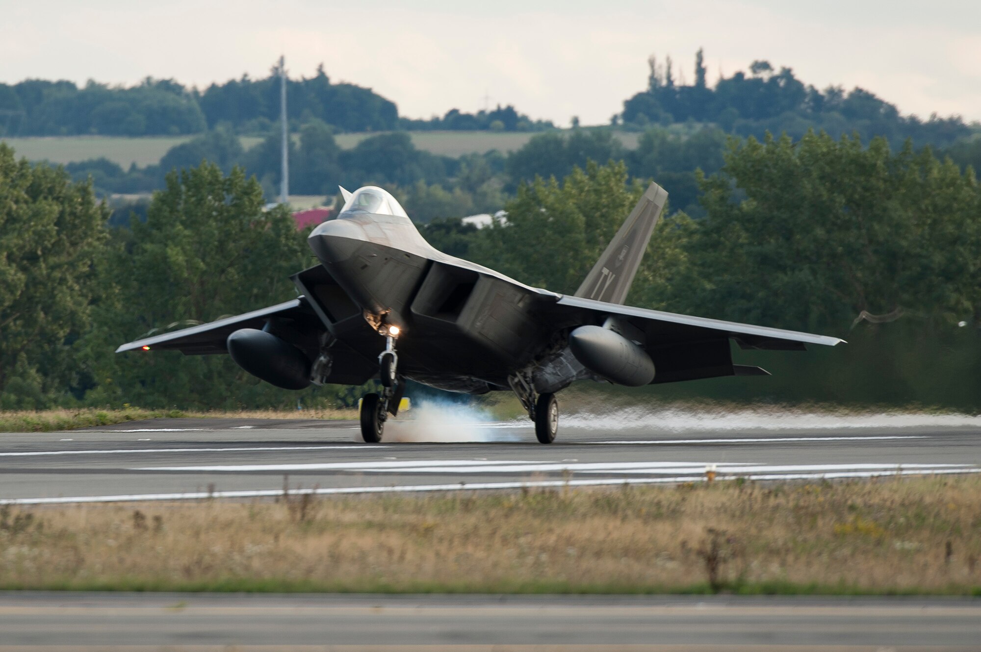 An F-22 Raptor fighter aircraft lands at Spangdahlem Air Base, Germany, Aug. 28, 2015 as part of the inaugural F-22 training deployment to Europe. The F-22s are deployed from the 95th Fighter Squadron at Tyndall Air Force Base, Fla., as part of the European Reassurance Initiative and will conduct air training with other Europe-based aircraft while demonstrating U.S. commitment to NATO allies and the security of Europe. (U.S. Air Force photo by Staff Sgt. Chad Warren/Released)
